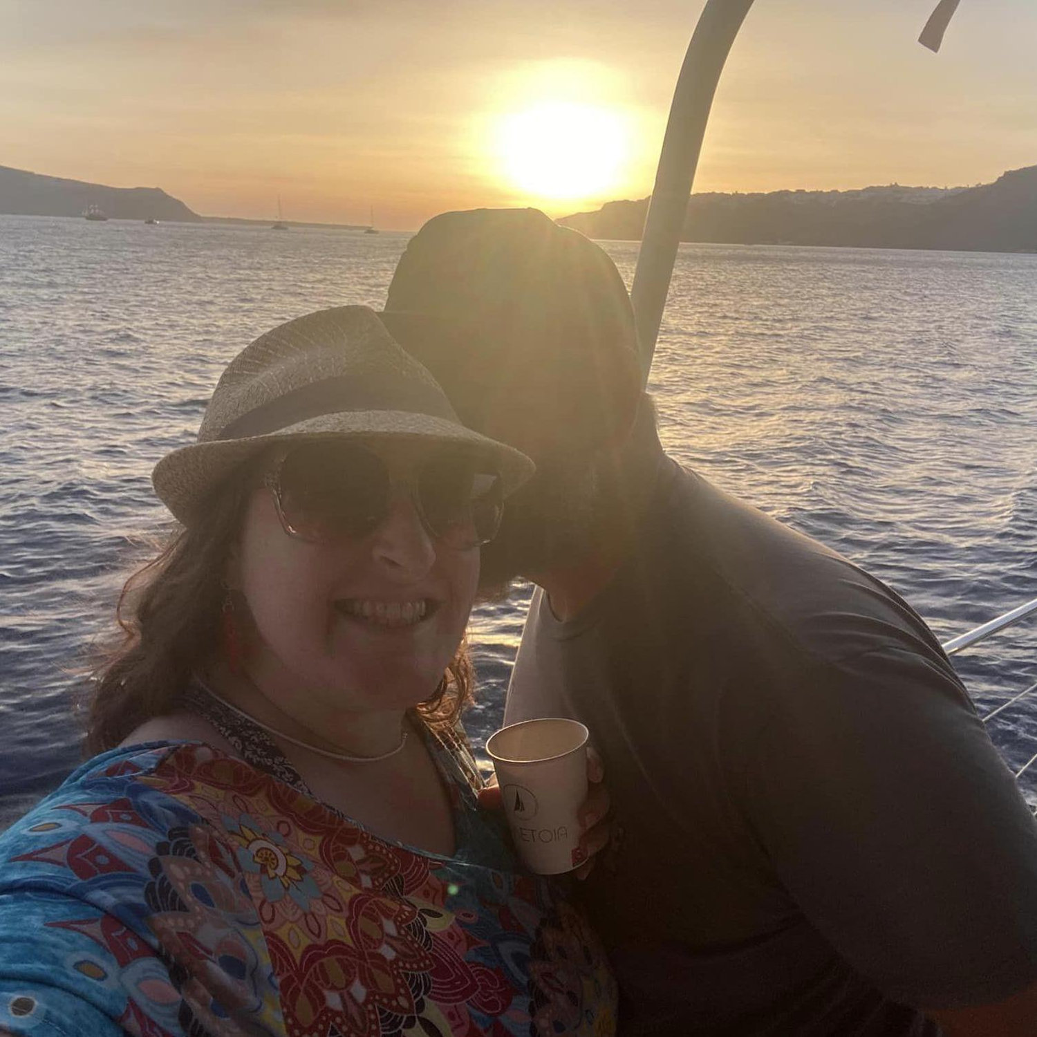 We love to travel! Here we are on a sunset cruise in Greece