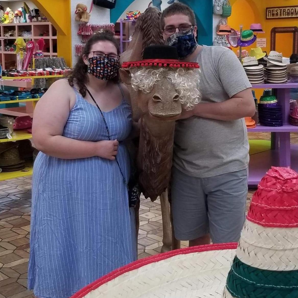 Just a girl, a guy, and camel wearing a hat. 
-North Carolina 2K20