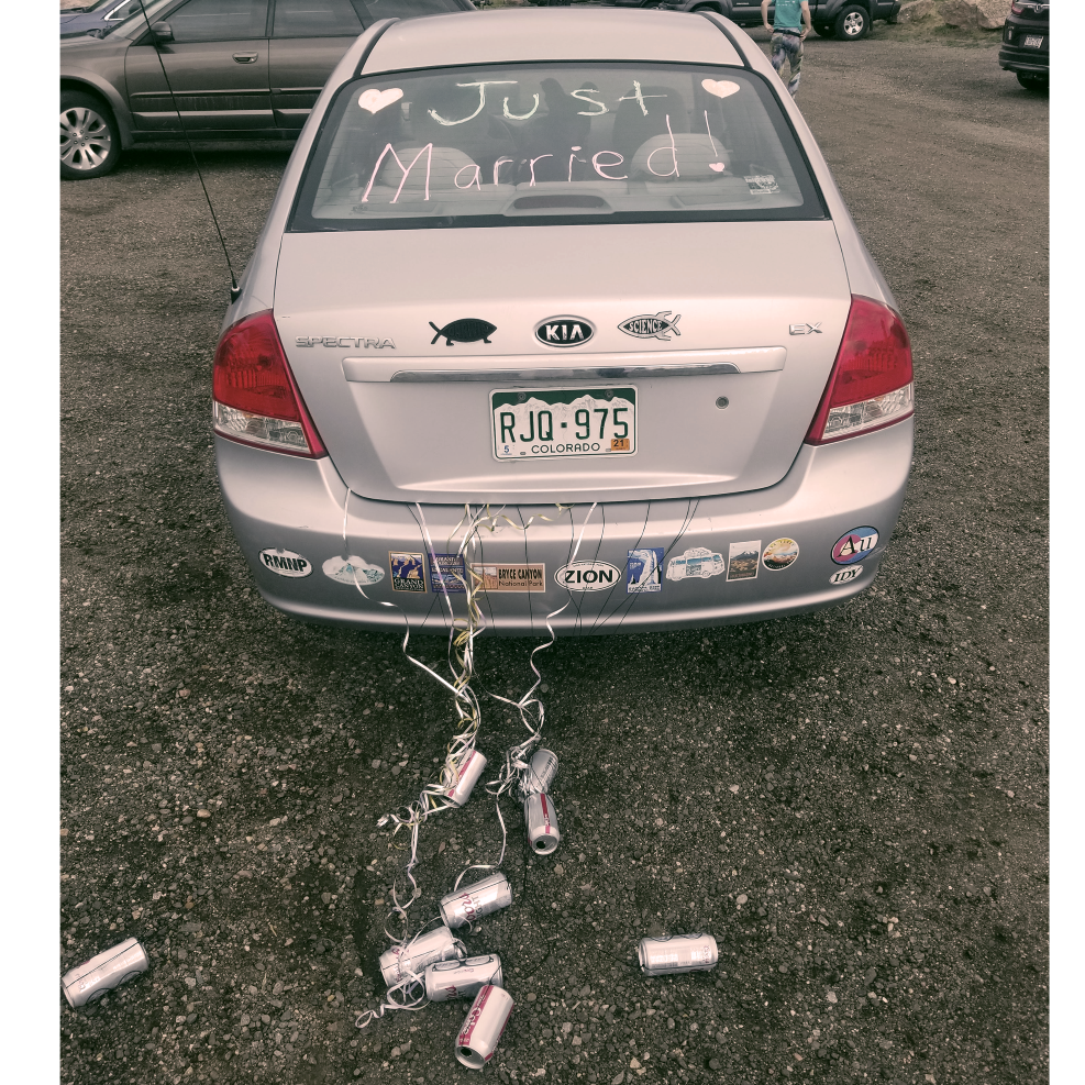Allie's little Kia with the "Just Married" sign and David's can train!