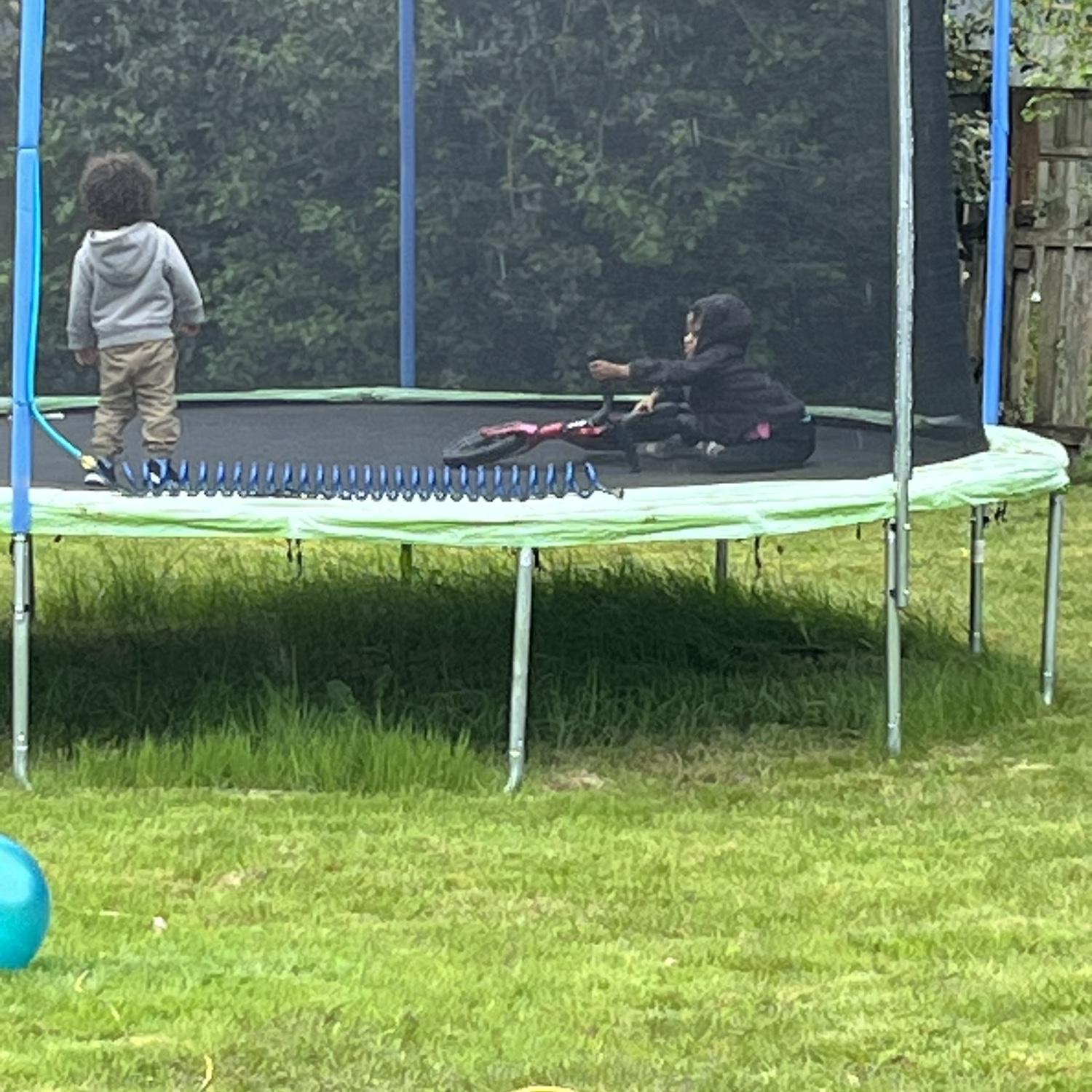 She really tried to ride the bike on the trampoline 😂