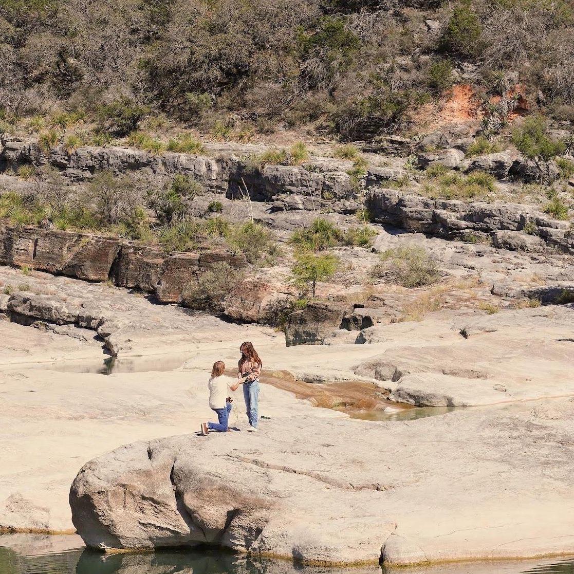 Chris proposing at Pedernales Falls State Park, October 2022