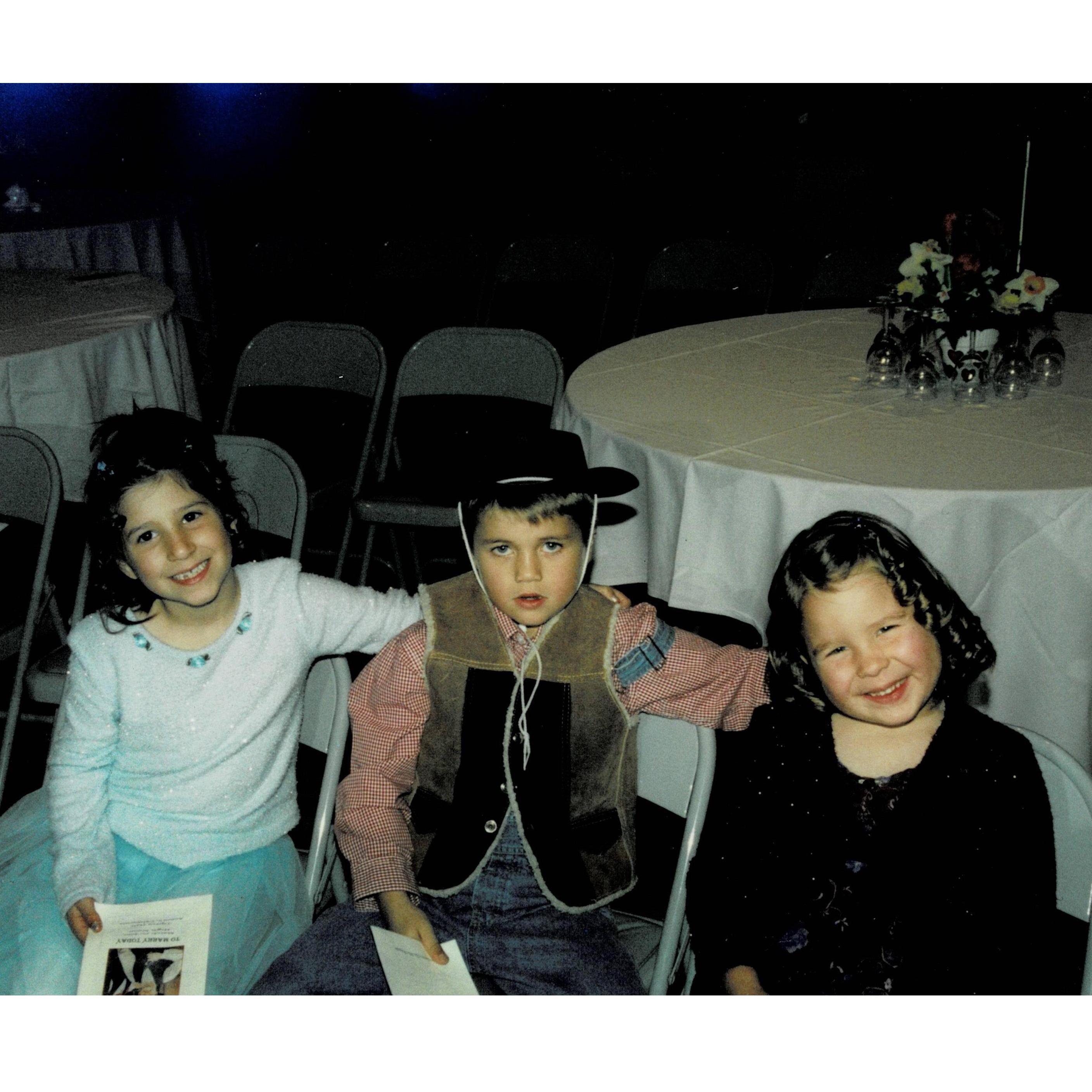 Marina, her cousin, and sister at a western-themed wedding