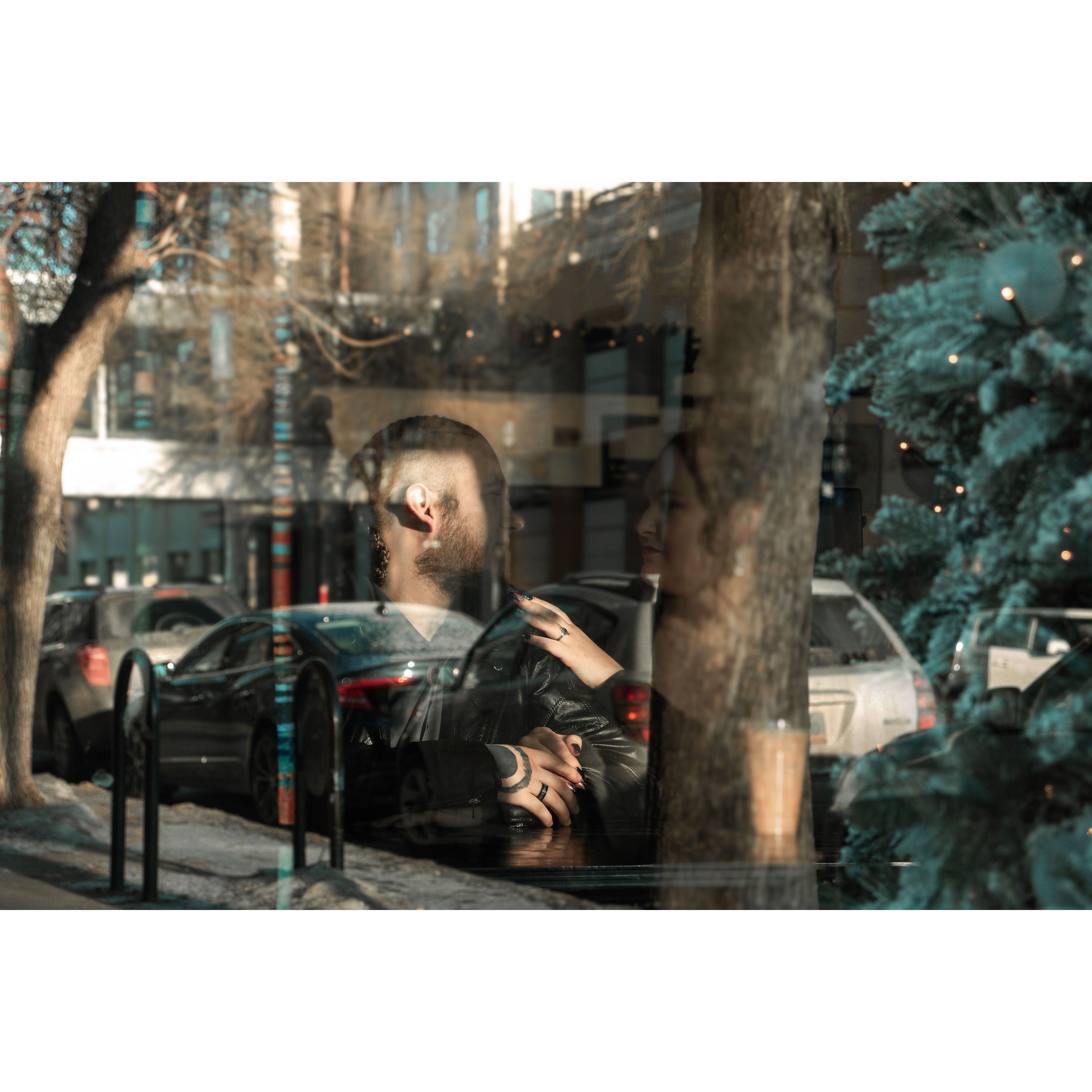 Taken from outside the window at our favorite coffee spot (Engagement shoot)