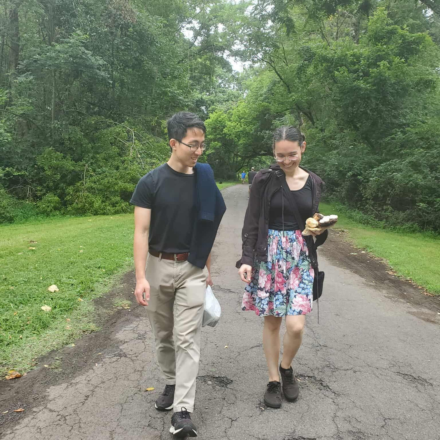 On a walk with Jimmy’s family in the lush woods of the American Northeast. Kayla is carrying a couple mushrooms and Jimmy is carrying a bag of sumac for tea.