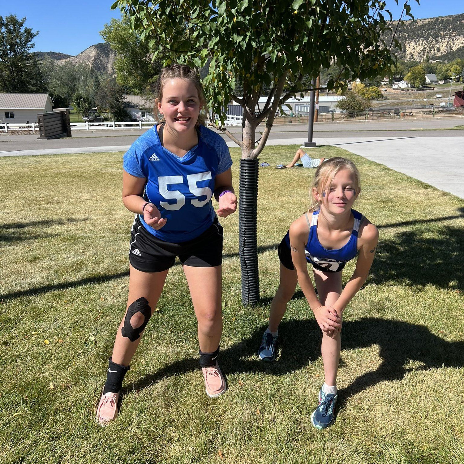 Kinsley (Volleyball) & Elise (Cross Country) in their jersey's.