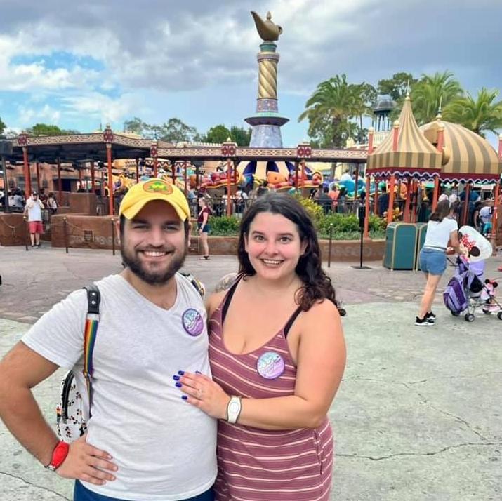 In front of Aladdin's Magic Carpets in Magic Kingdom where we met