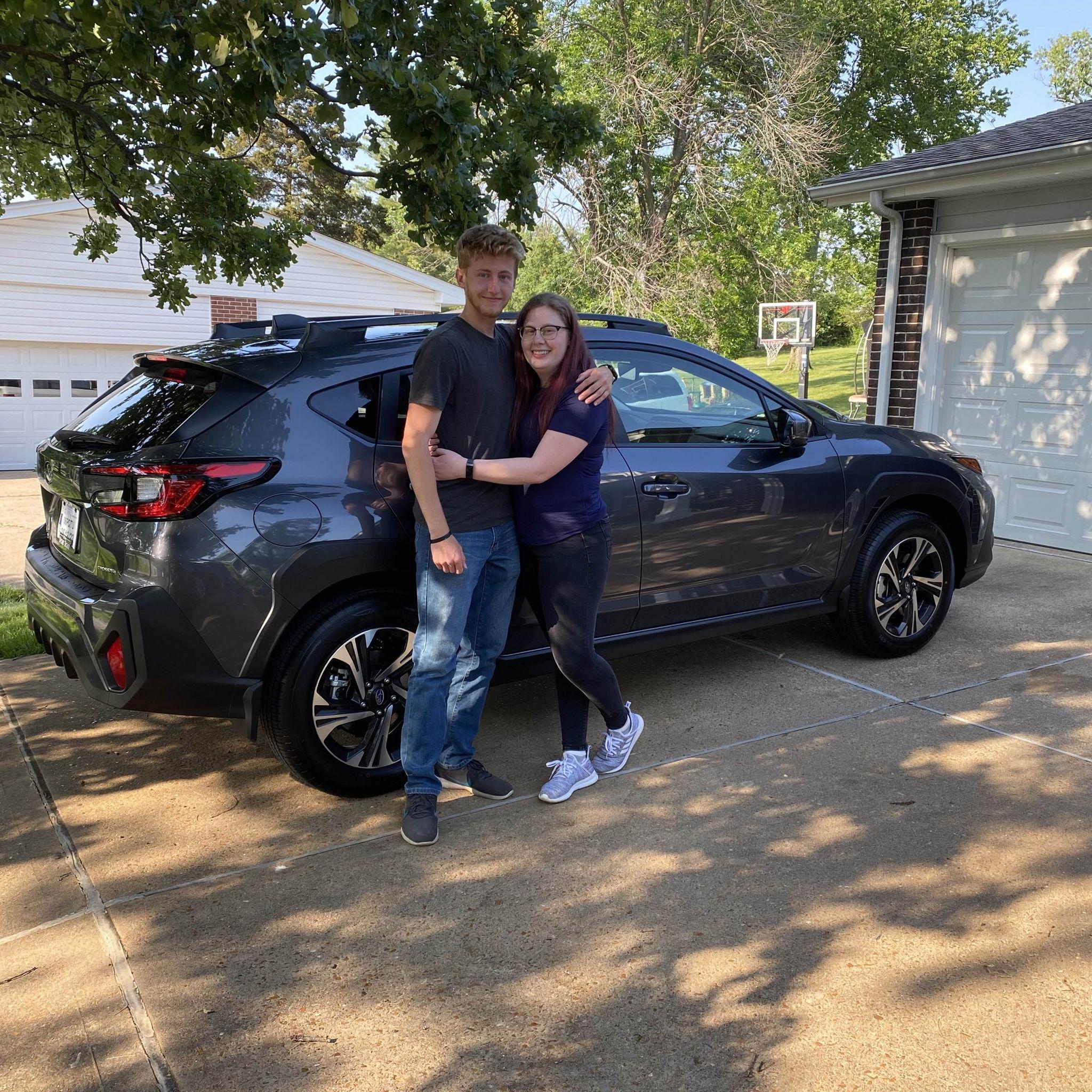 Our first picture together. This was after buying my first car. This was the day we both met eachother's parents