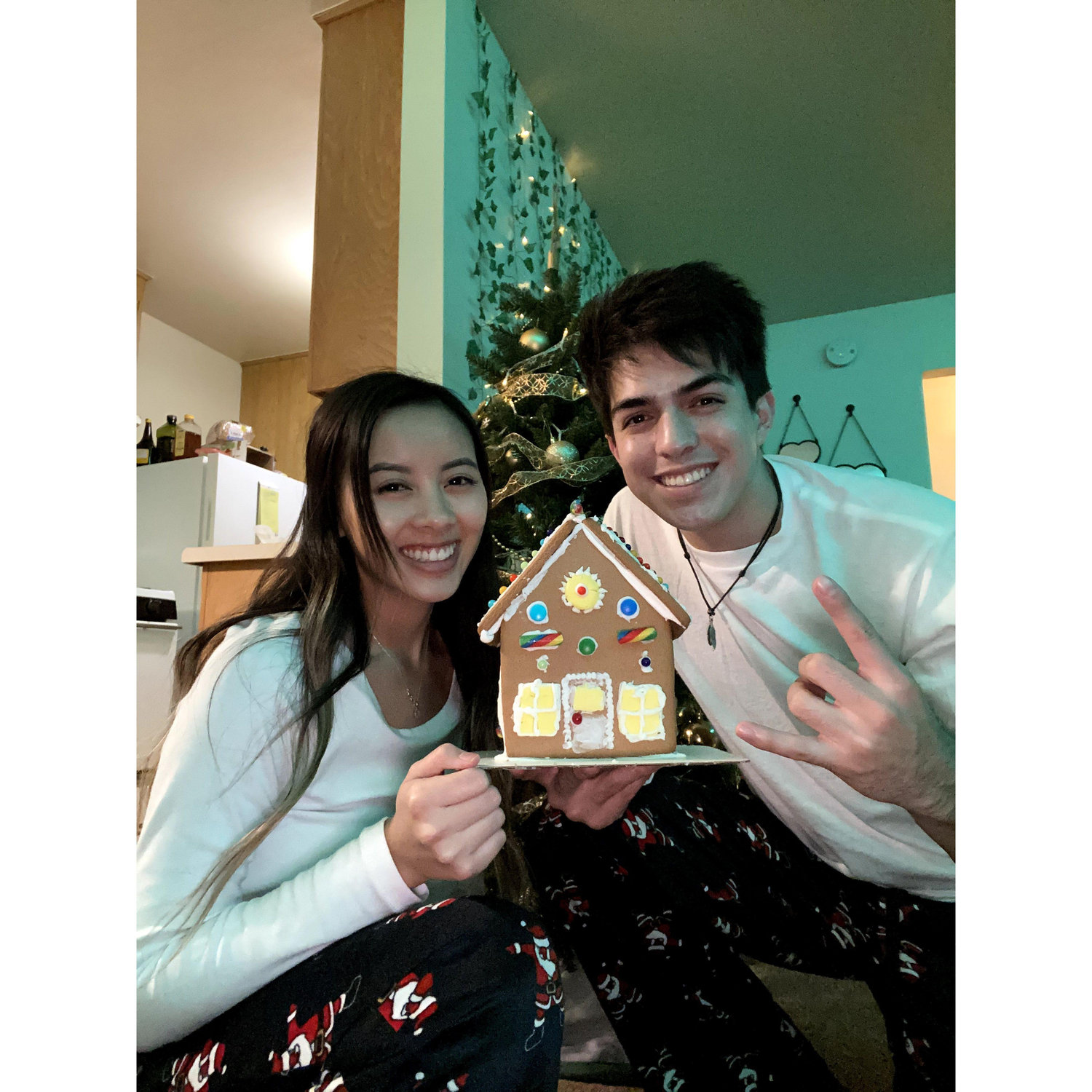 December 12, 2020 - First time making gingerbread houses! And behind them is the first Christmas tree they got to decorate together!