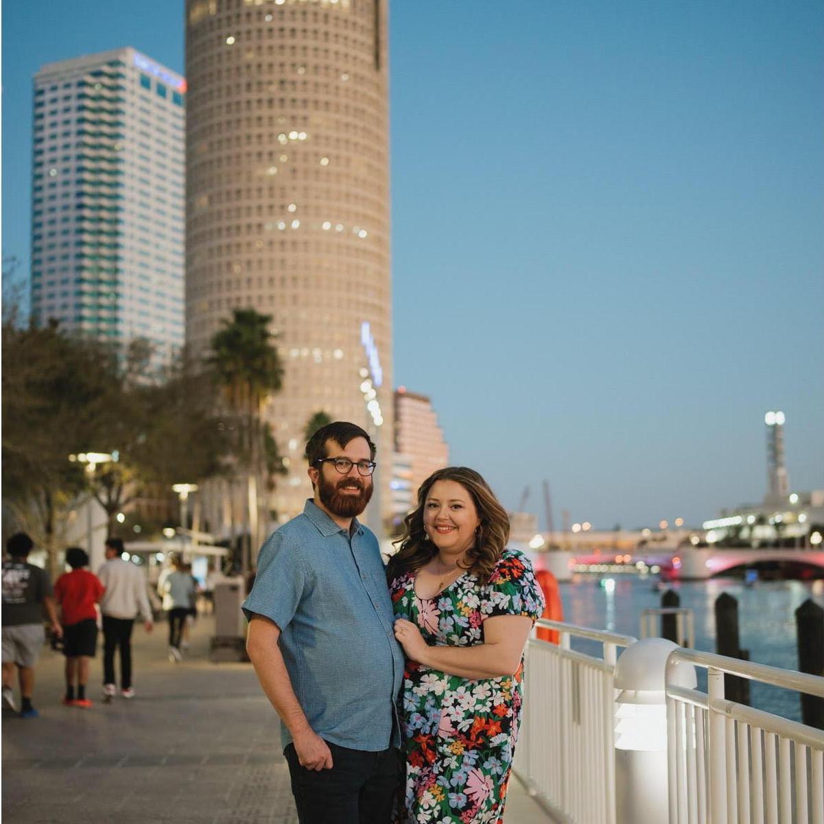 Our wonderful photographer, Regina as the Photographer, took our engagement photos in Downtown Tampa on the Riverwalk where we were engaged.