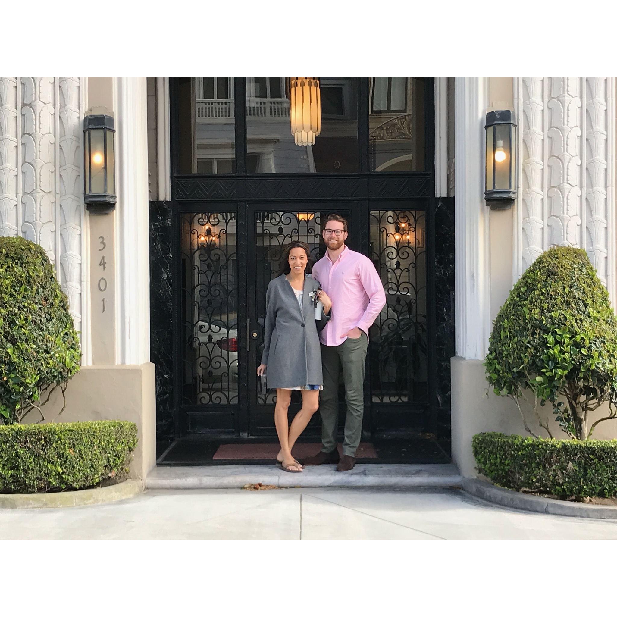 Us in front of our first (and current) apartment together!