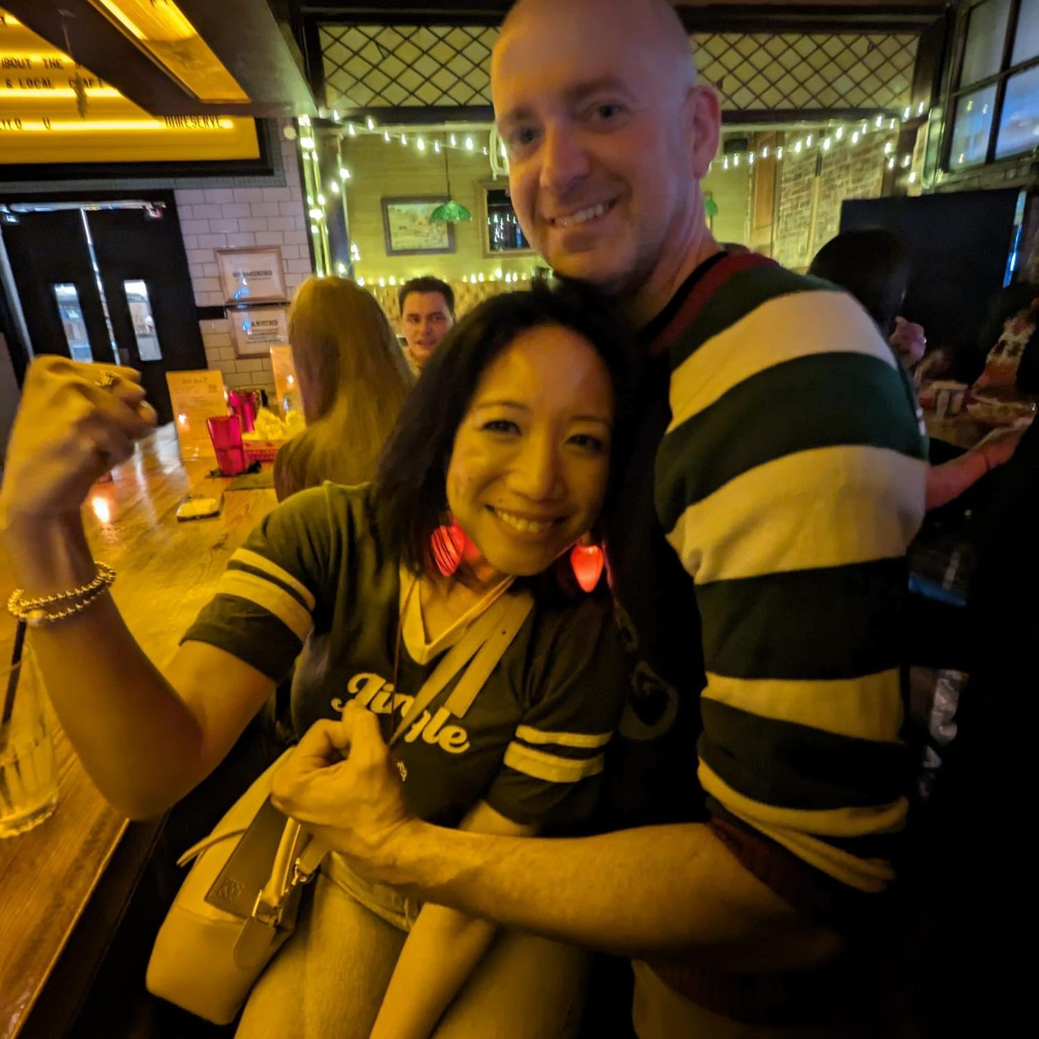 December 2023: at the annual holiday tradition, Jingle Bar. This was when we were "just dating" - before we were "official." (But everyone thought we were!)