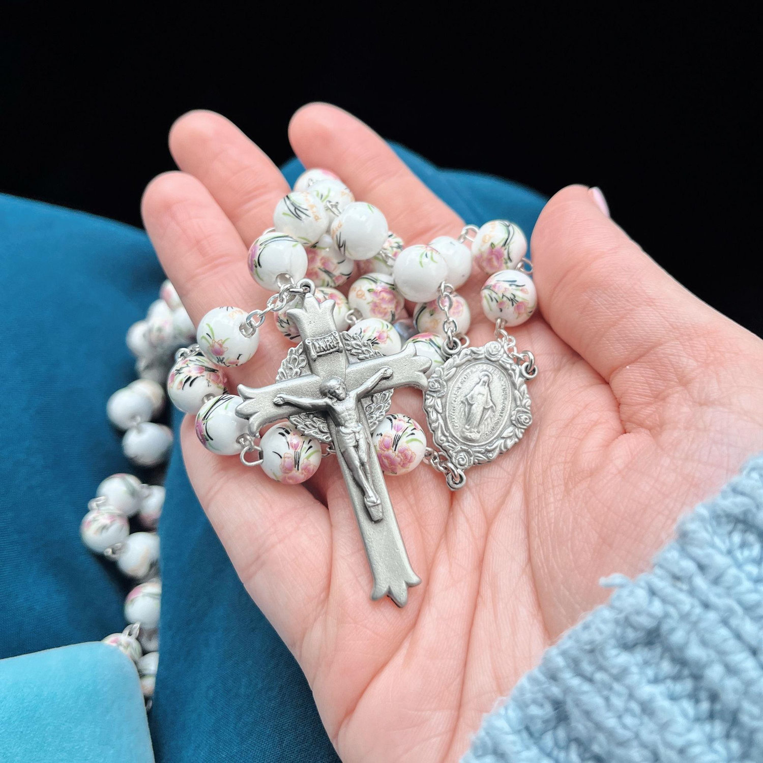 Geno proposed with the ring hidden under this Rosary