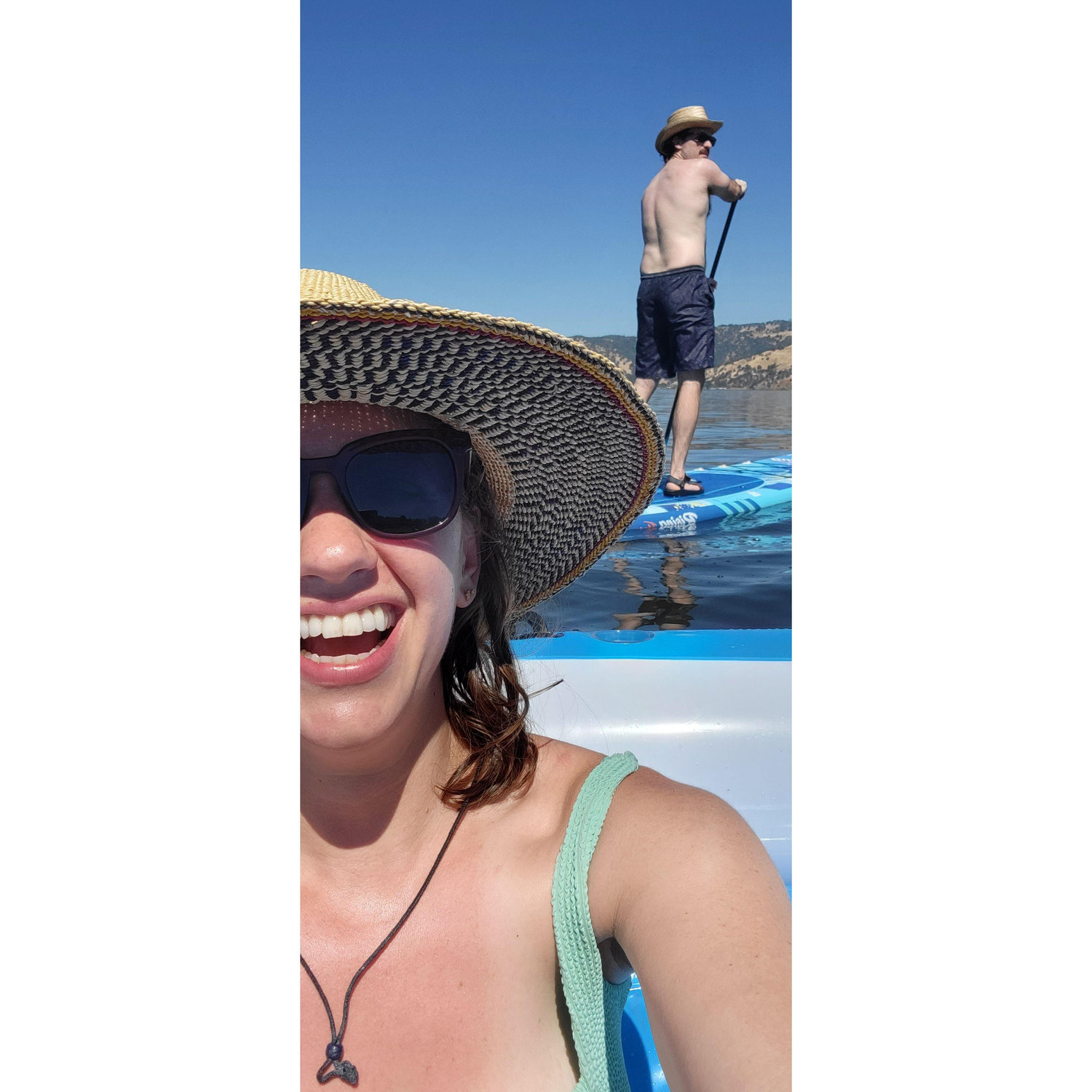 Tommy towing Ava's raft (plus several beers in the cooler) on Clear Lake by paddleboard. Was 115 degrees that weekend. July 2023.