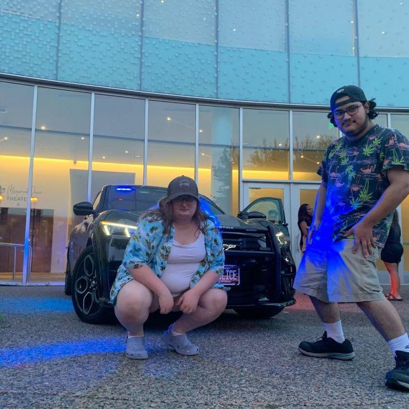Looking gangsta in front of cop car at party on the plaza