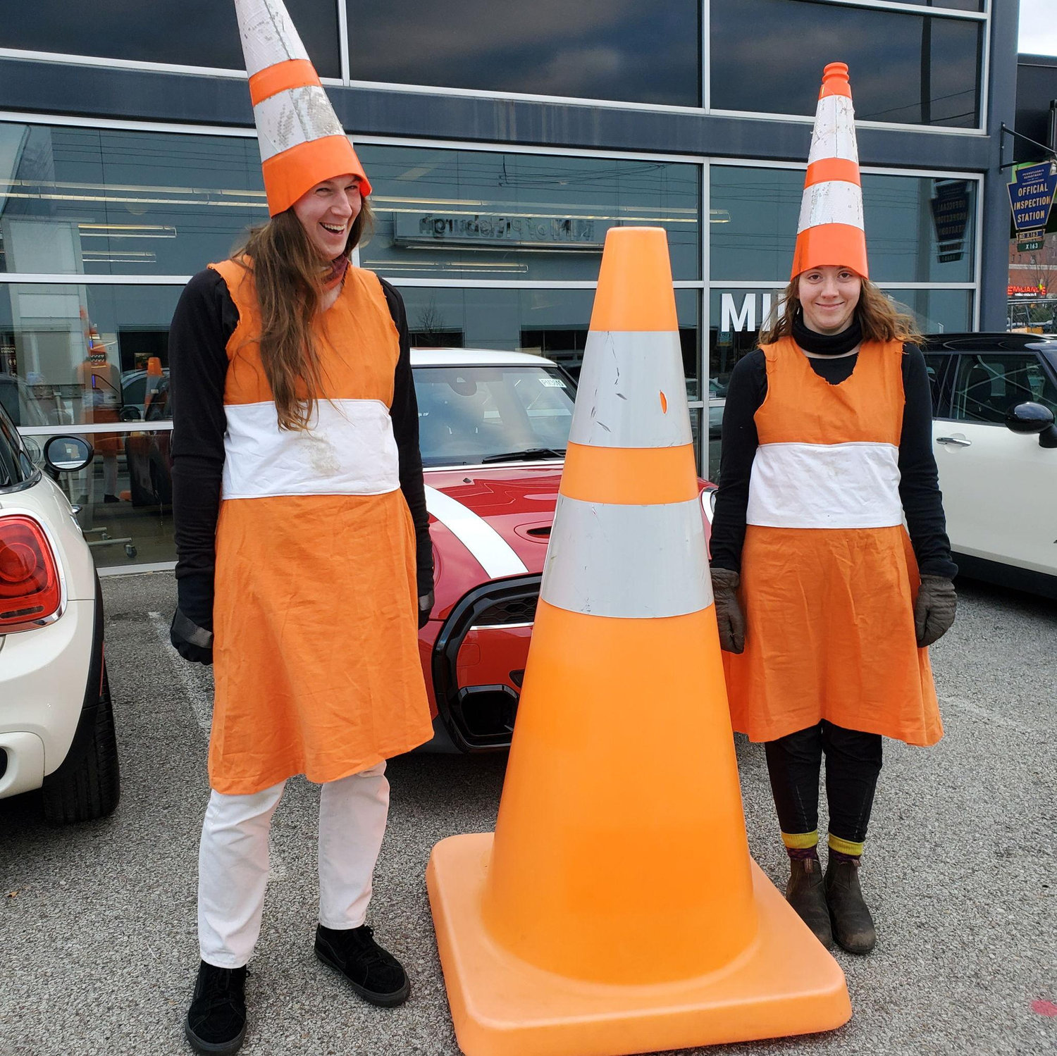 Dressed up in our traffic cone halloween costume to visit the giant cone at the mini cooper dealership 11.14.2022