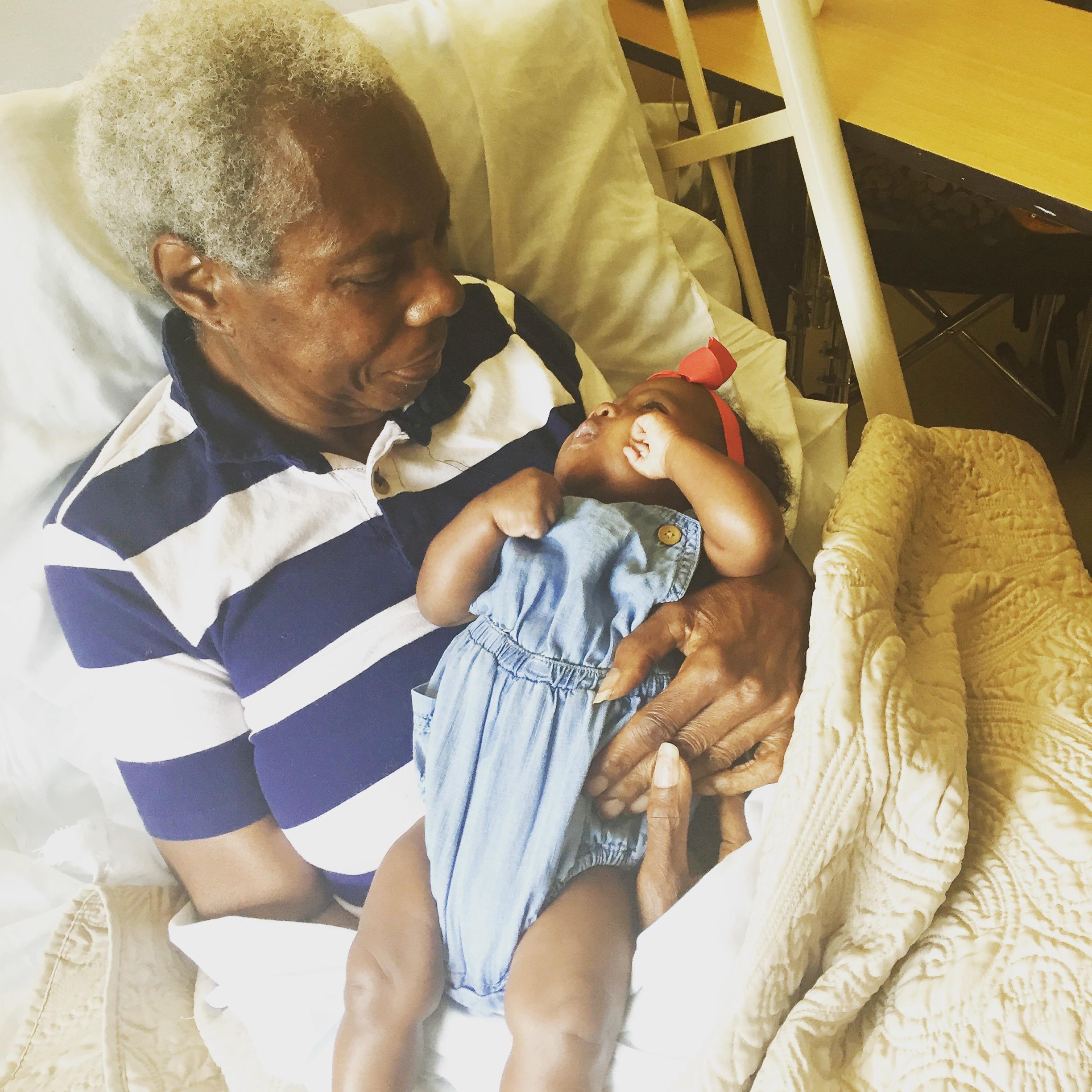 Aaliyah’s mama Joyce holding Avery for the first time