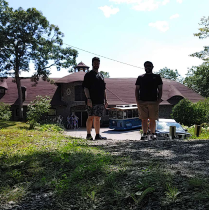 July 30, 2023 - After exploring Lucknow Mansion (aka, Castle in the Clouds), we posed in front of the carriage house with the trolley that brought us to the mountaintop estate several hours before.