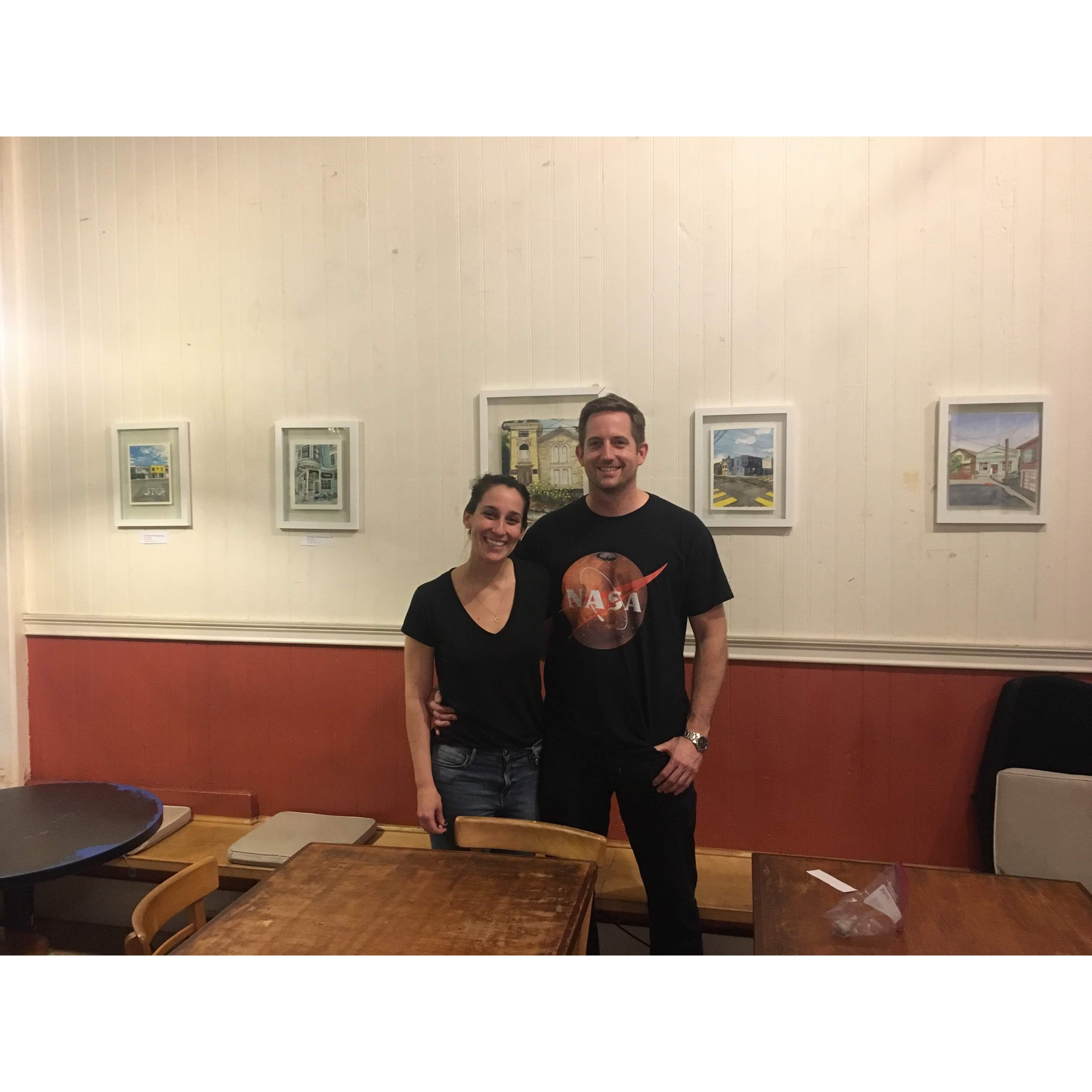Chris helping Becca hang up her art for her art show