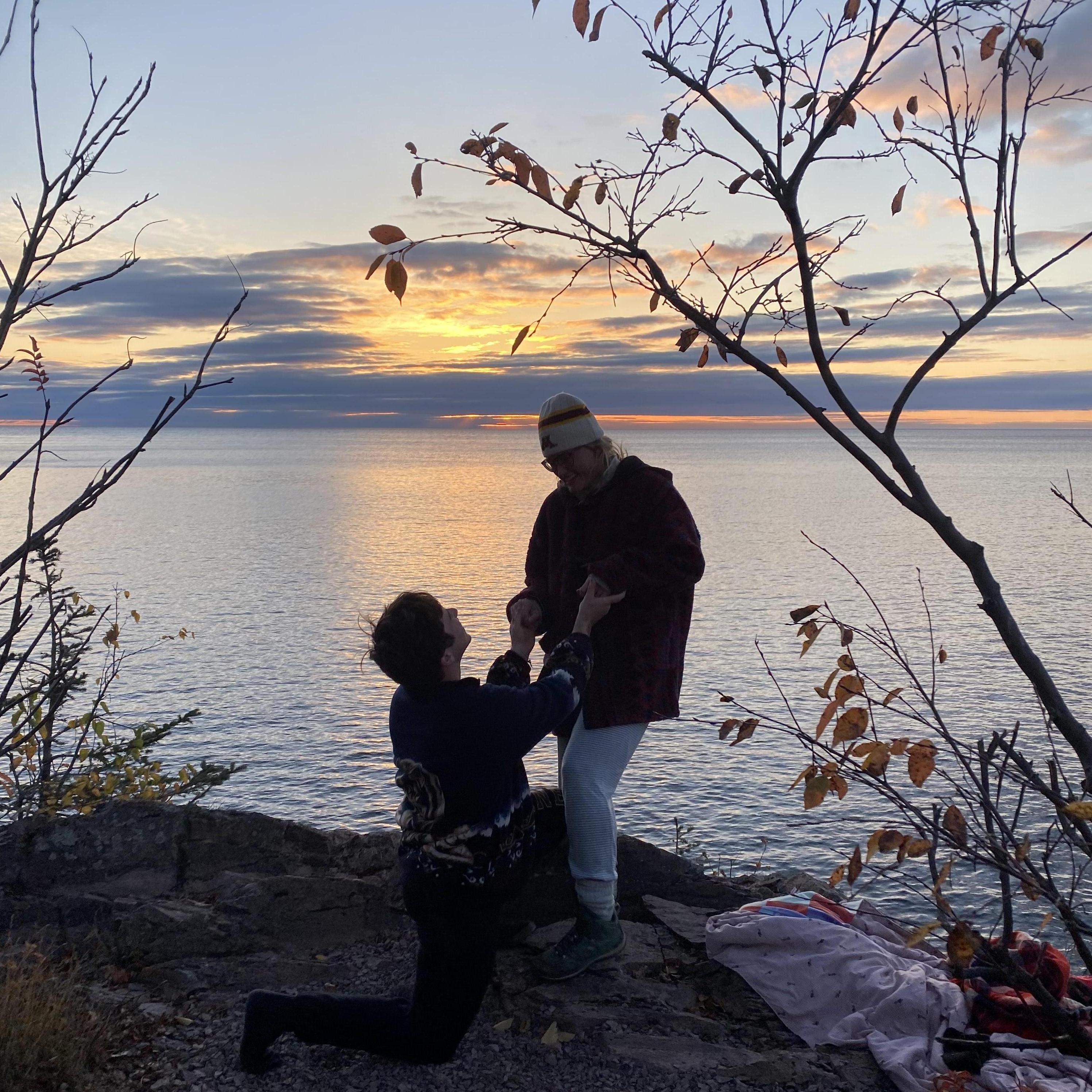 Proposal in pajamas during sunrise at Tettegouche State Park
