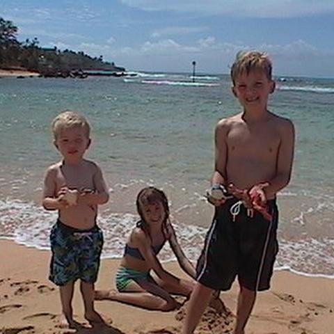 Julie, her brother Eric (right), and cousin Jackson in Poipu in 2001.