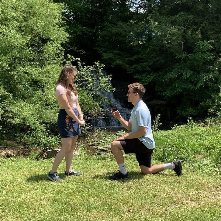 We got engaged at on May 29, 2022, in front of the waterfall at Christine's parents' lake. :)