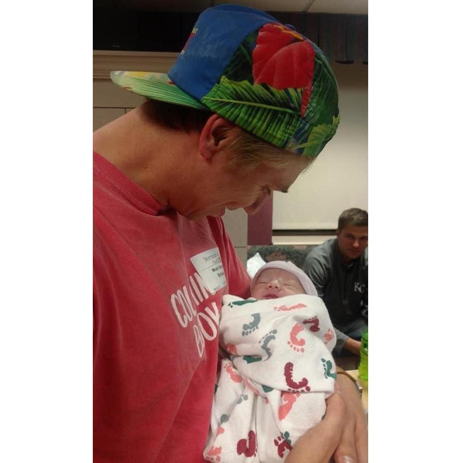 Micah's first time holding Carson Dease, ring bearer. Carson is just minutes old!