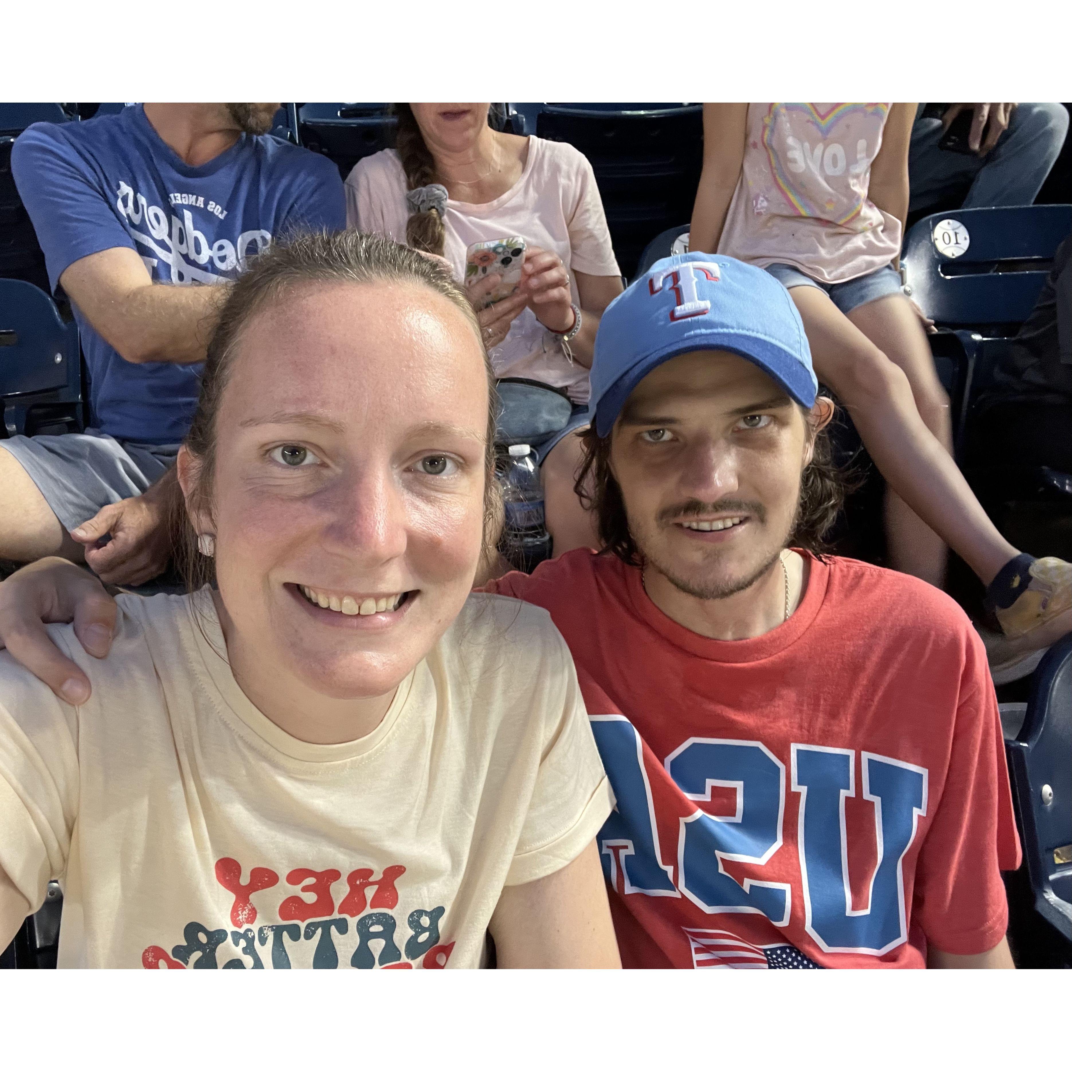 During our first trip together. We were with family, watching the Texas Rangers against the Washington Nationals. Nationals Park, Washington, D.C.