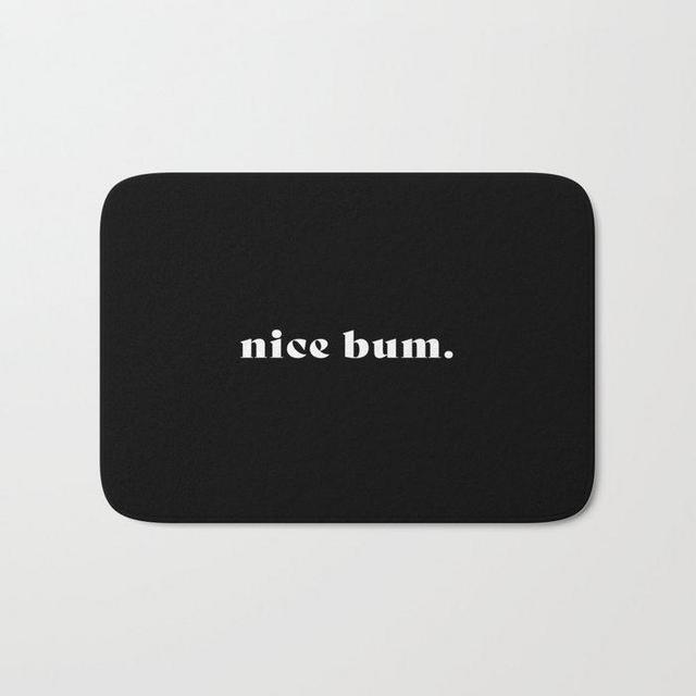 nice bum. (black background serif font) Bath Mat