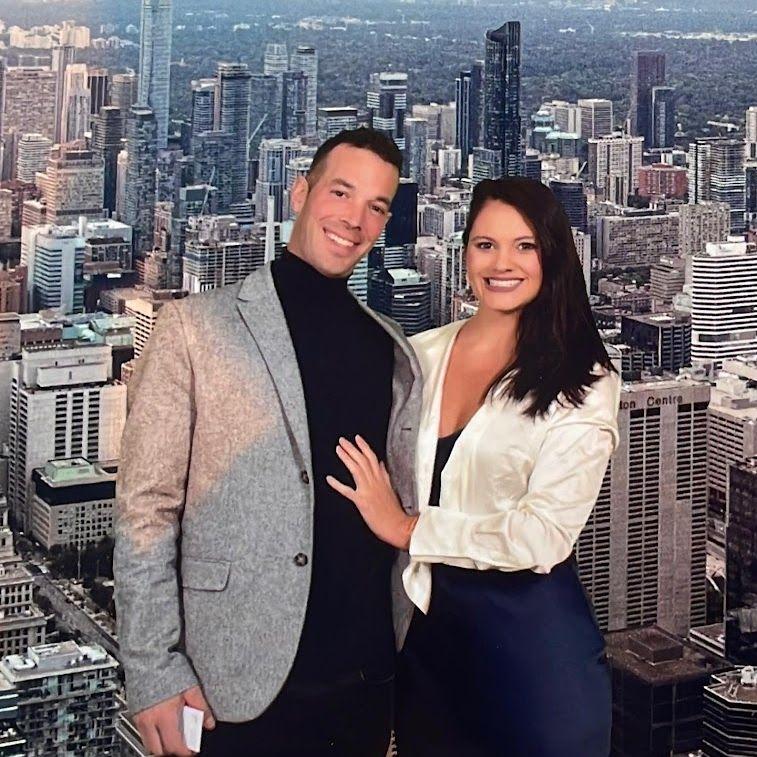 Michelle's first trip to Canada! They had dinner at the top of the CN Tower, but this is a fake background :D