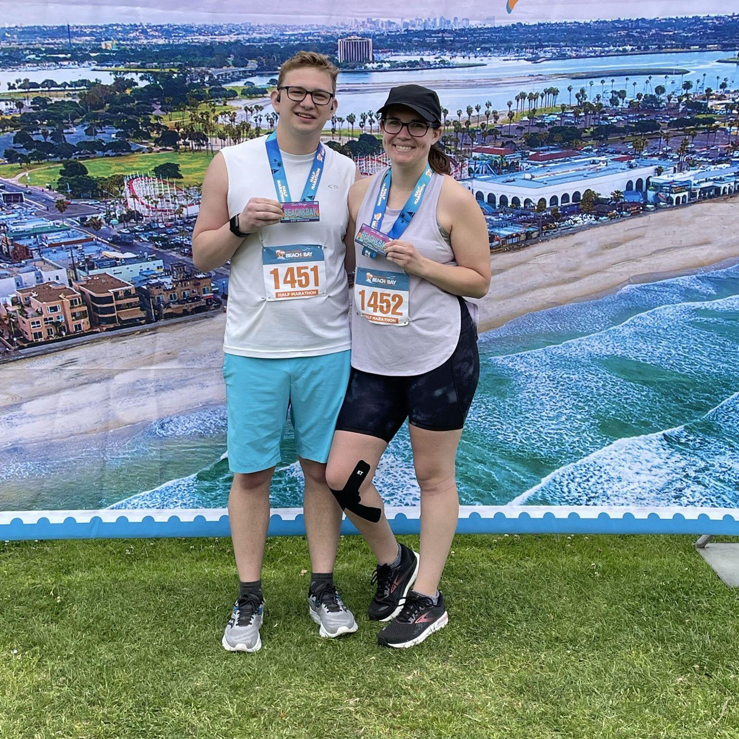 We did it! We completed the Beach & Bay Half Marathon in San Diego, CA in April 2022. We may look happy, but Brian threw up and Abby hobbled over in knee pain before taking this photo.