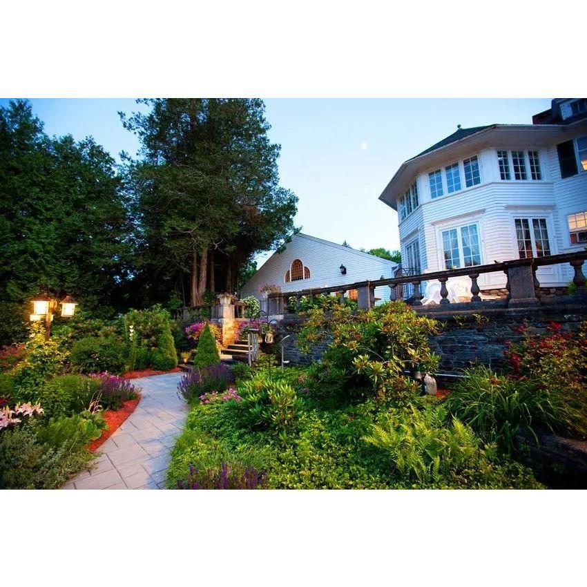 The garden path at the estate winds invitingly through lush greenery, offering a tranquil journey beneath whispering leaves, where every step is enveloped in the soft embrace of nature's quiet beauty.