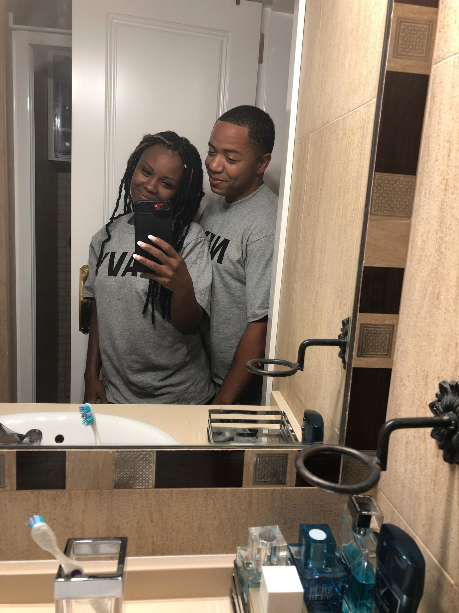 First night living with one another in Spain. Travis buys matching Navy shirts.