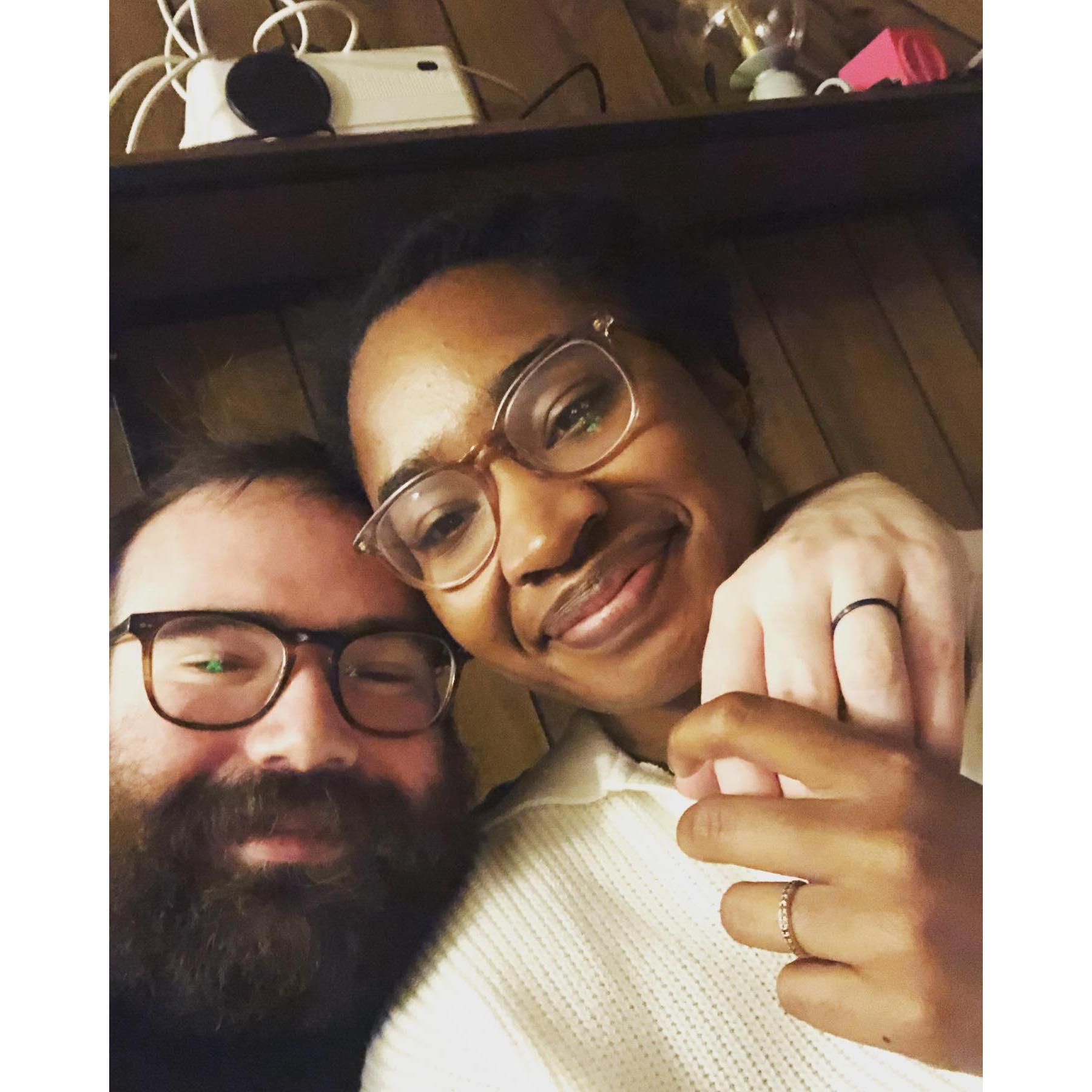 Matching engagement rings (feat. wood paneling in our tiny Pittsburgh apartment) (~November 2022)