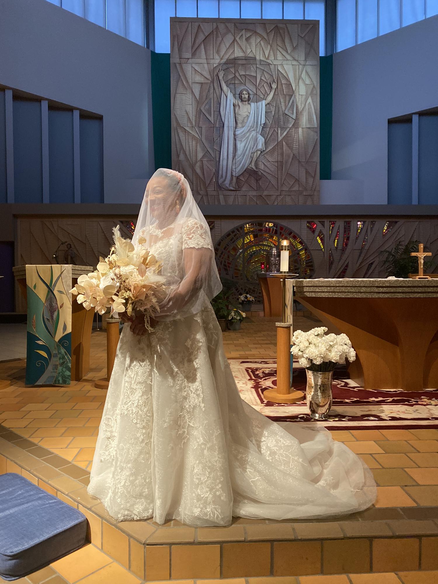 Ivory ball gown with beaded floral appliqué and chapel train designed by Oleg Cassini