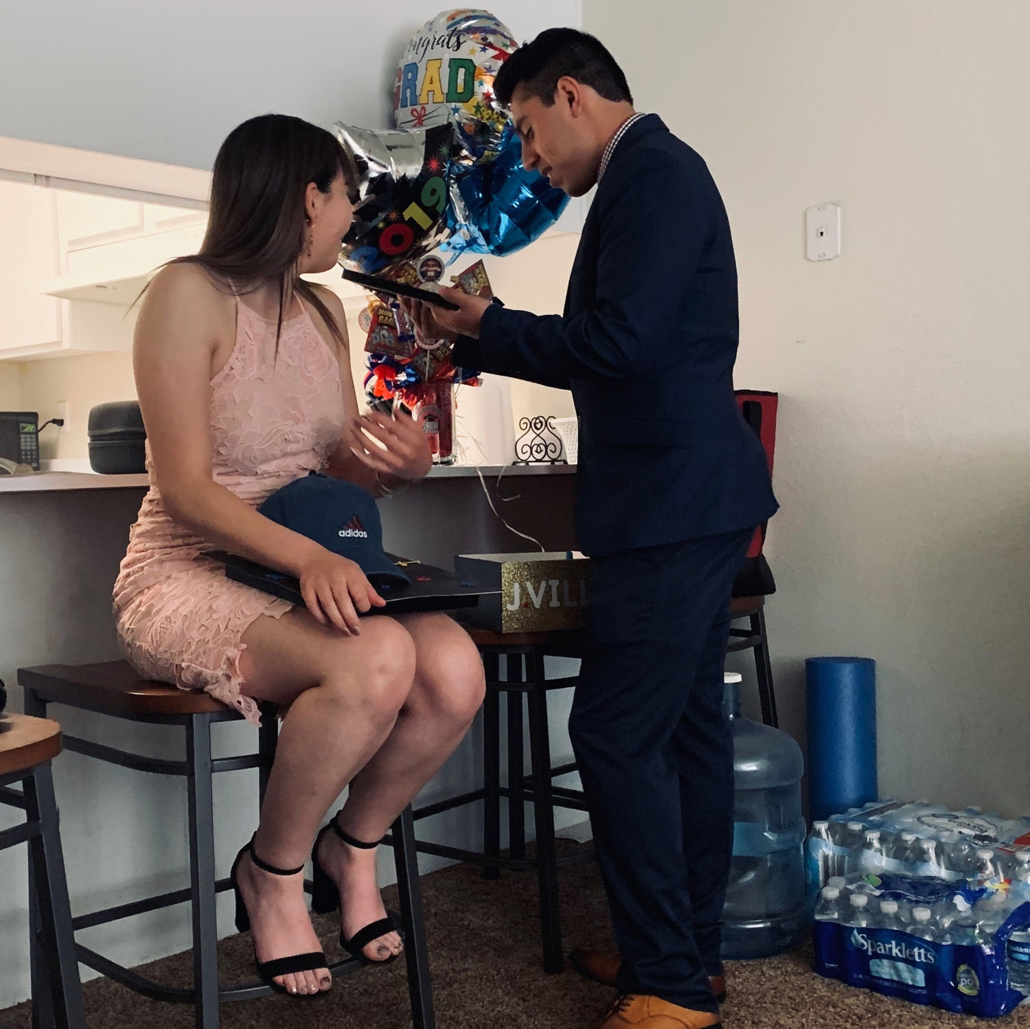 The day Jesus graduated college. He's opening his gift while his best friend took this picture. It's our very first picture together.