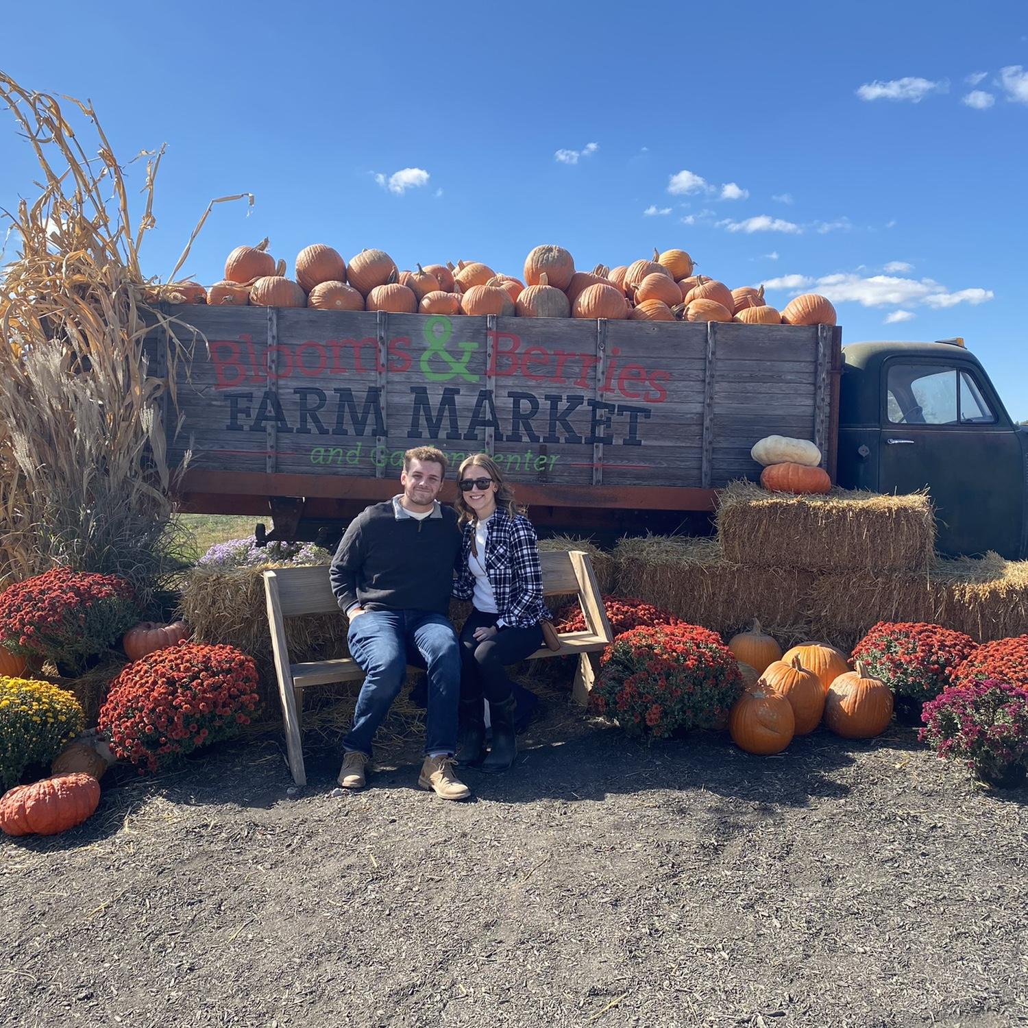 Enjoying the fall festivities by going to a fall market and getting pumpkins.