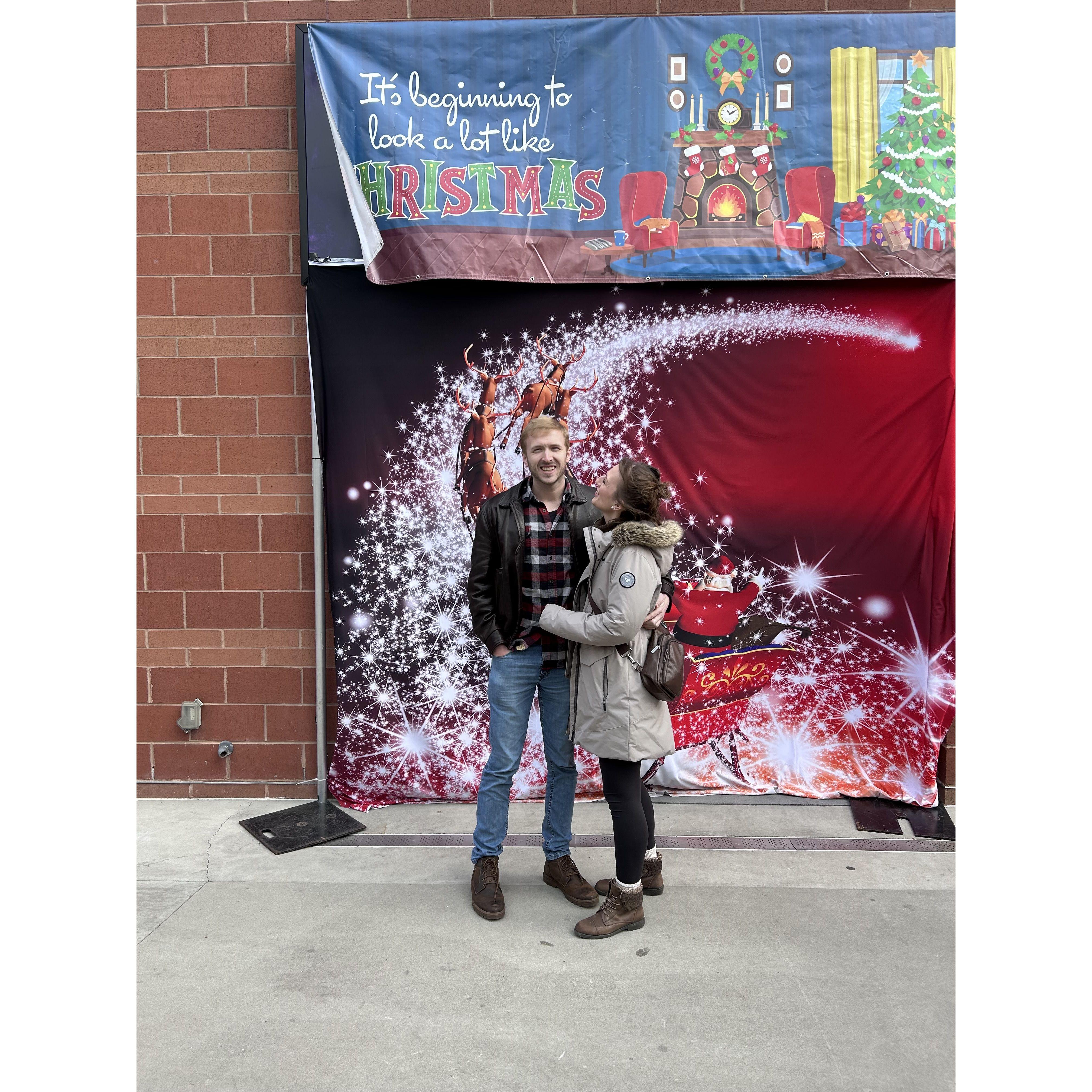 Cheesy pic in front of a cheesy Christmas backdrop