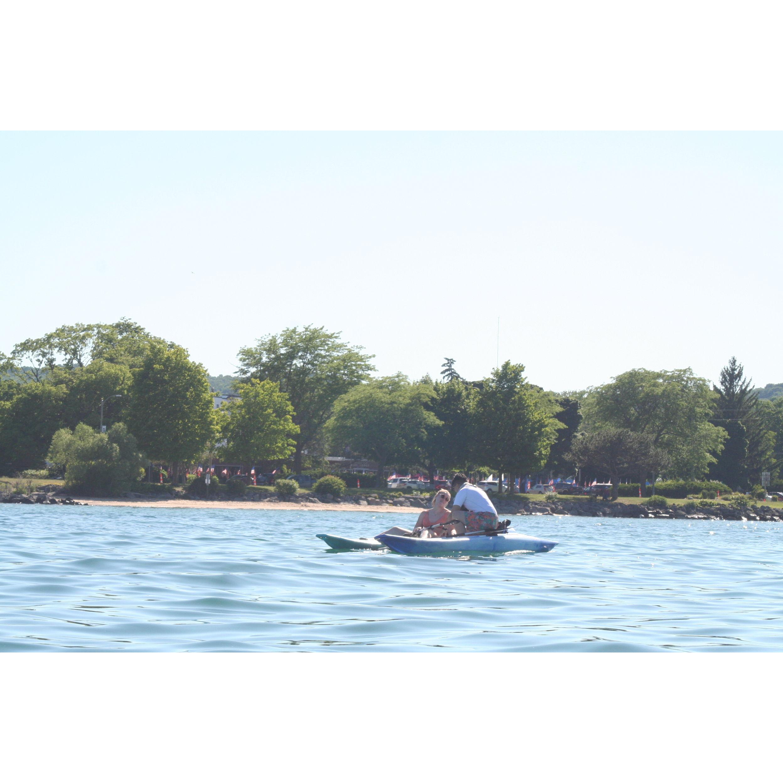 Tianna proposing to Bria on the Grand Traverse Bay. (Yes, she actually knelt in a kayak. No, she didn't drop the ring. Yes, you should be very impressed.)