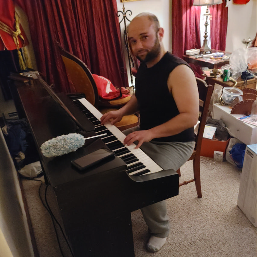 Jan. 22, 2021 - Joe takes a break during our set-up process to play our new piano.