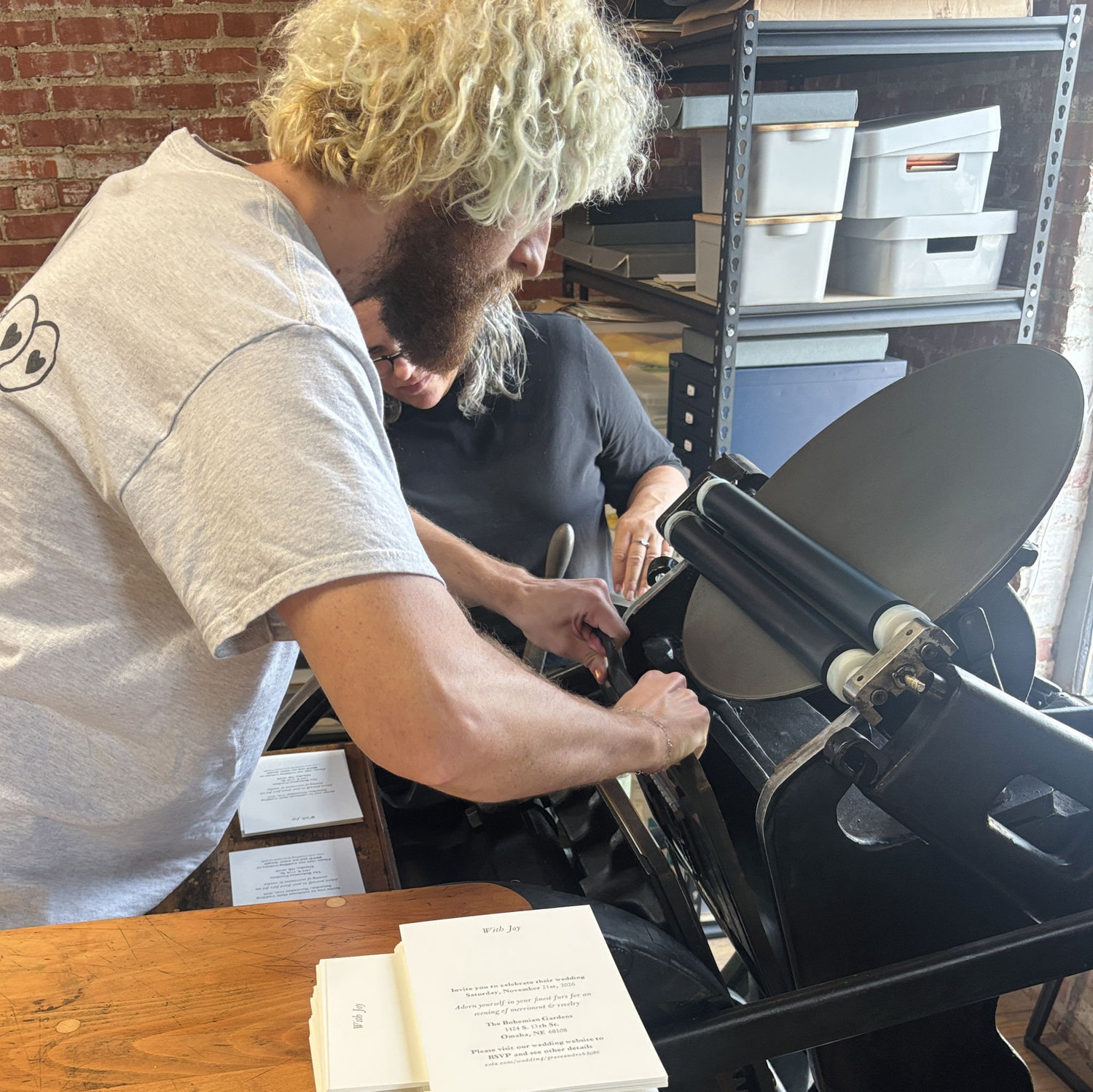 Rob and Kim putting the type into the press! dangerous!