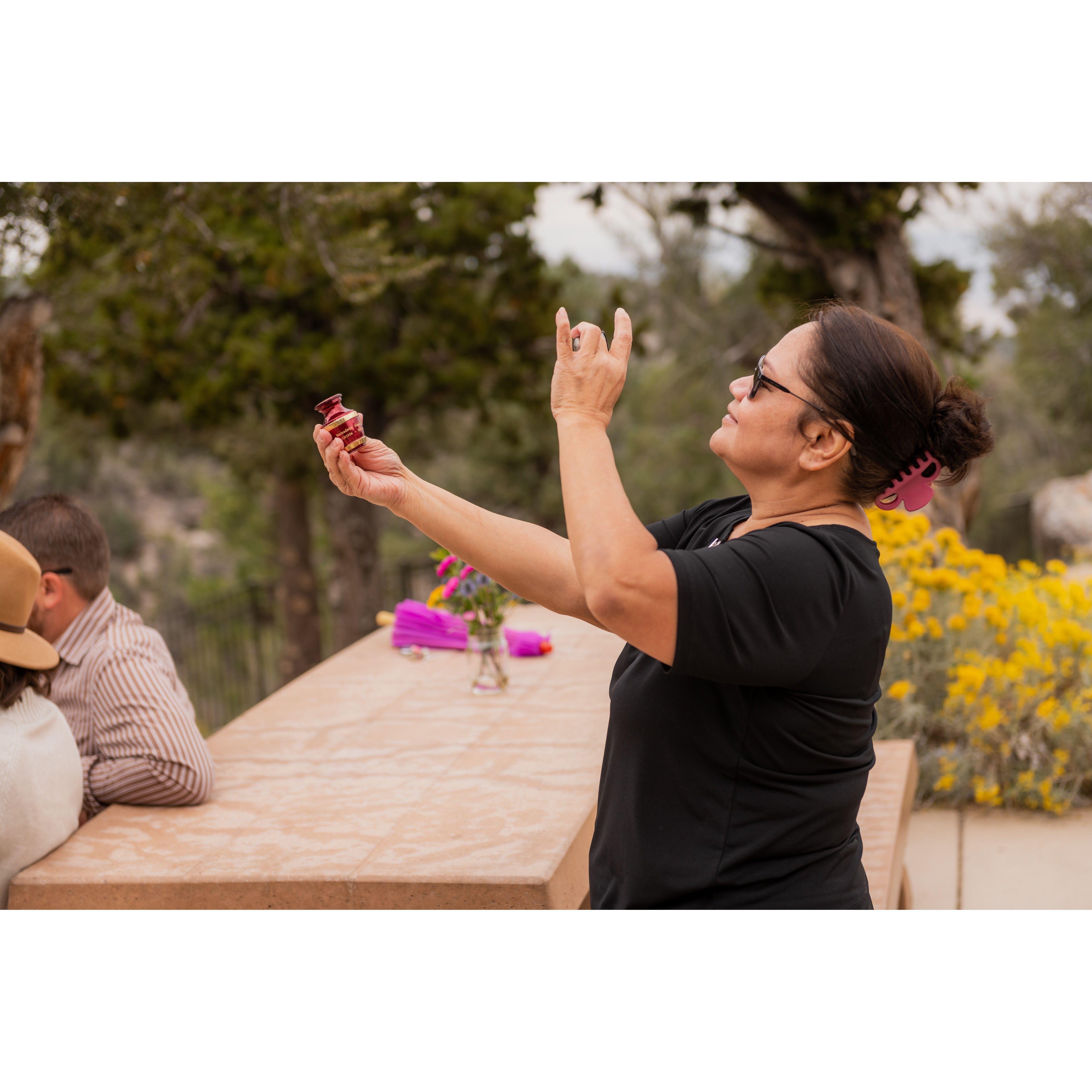 Vickie is making sure Bernie has a front-row seat to the wedding. She's also filming to show Jeanne later on.