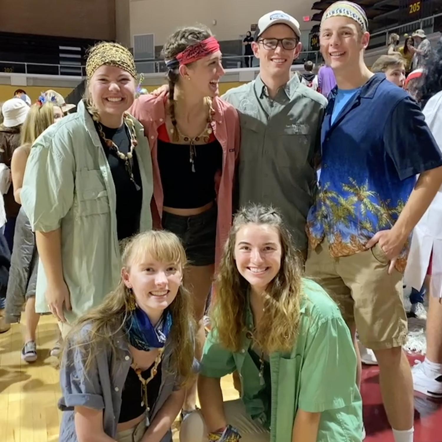 Halloween 2021: We are both invited by our friends to be part of a group 'Survivor' halloween costume. This is the first photo we are ever in together. We won't start dating for another two years.