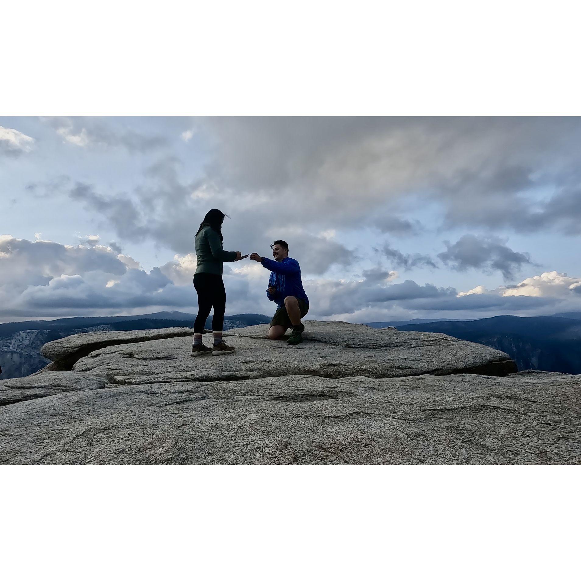 Both holding onto the ring making sure it doesn't drop 3,000 feet.