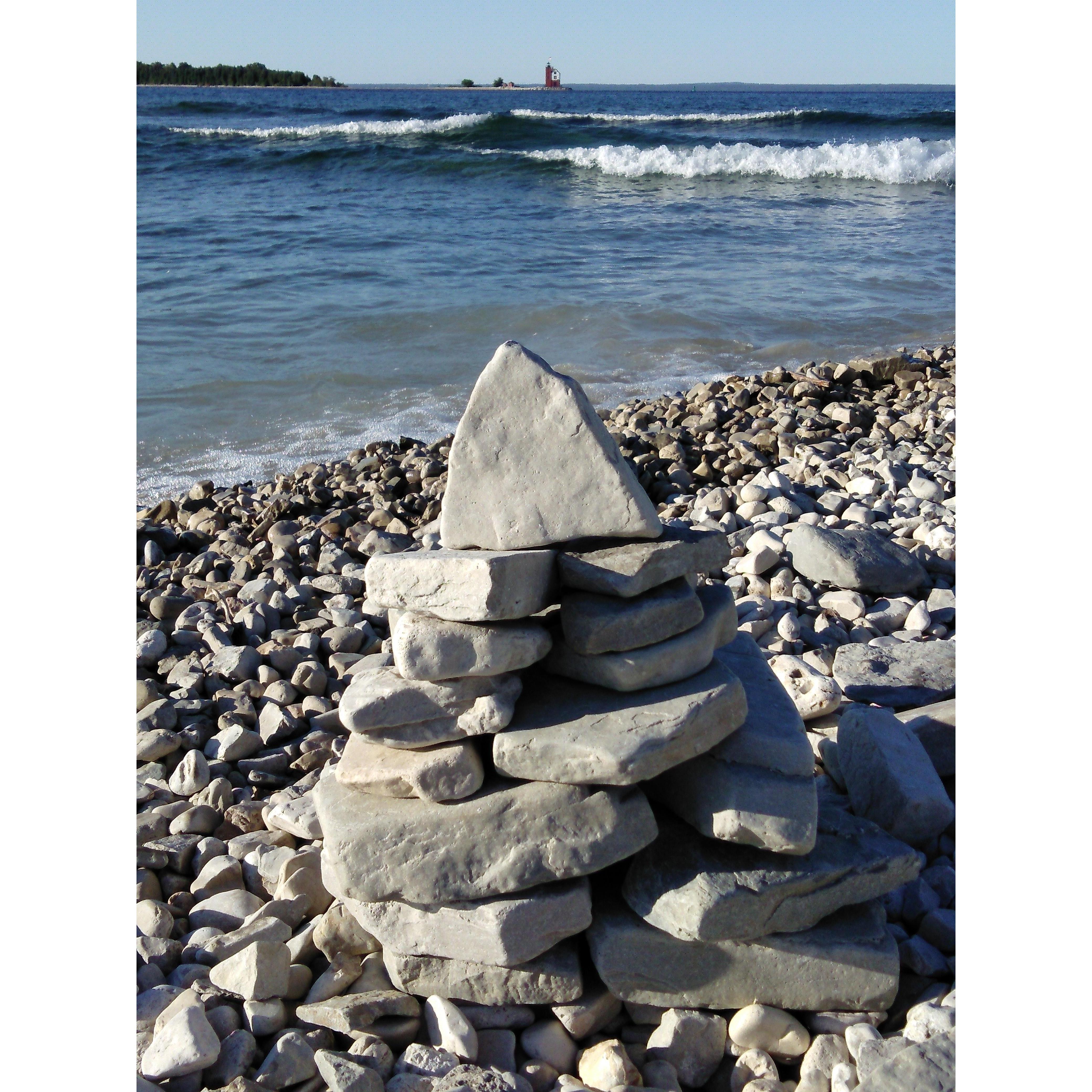 One of our happy places. Beach on Mackinac Island, Michigan looking at Round Island lighthouse.