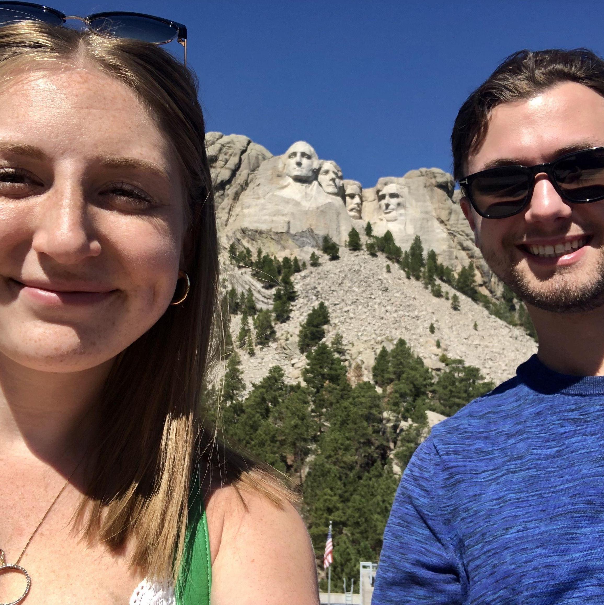 Smiling at Mount Rushmore on our cross country road trip!