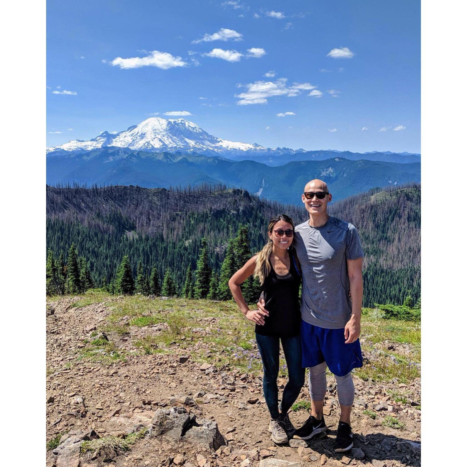 Standing in front of Mount Rainer in Washington State. This travel assignment is where we found our love for hiking & the outdoors!
