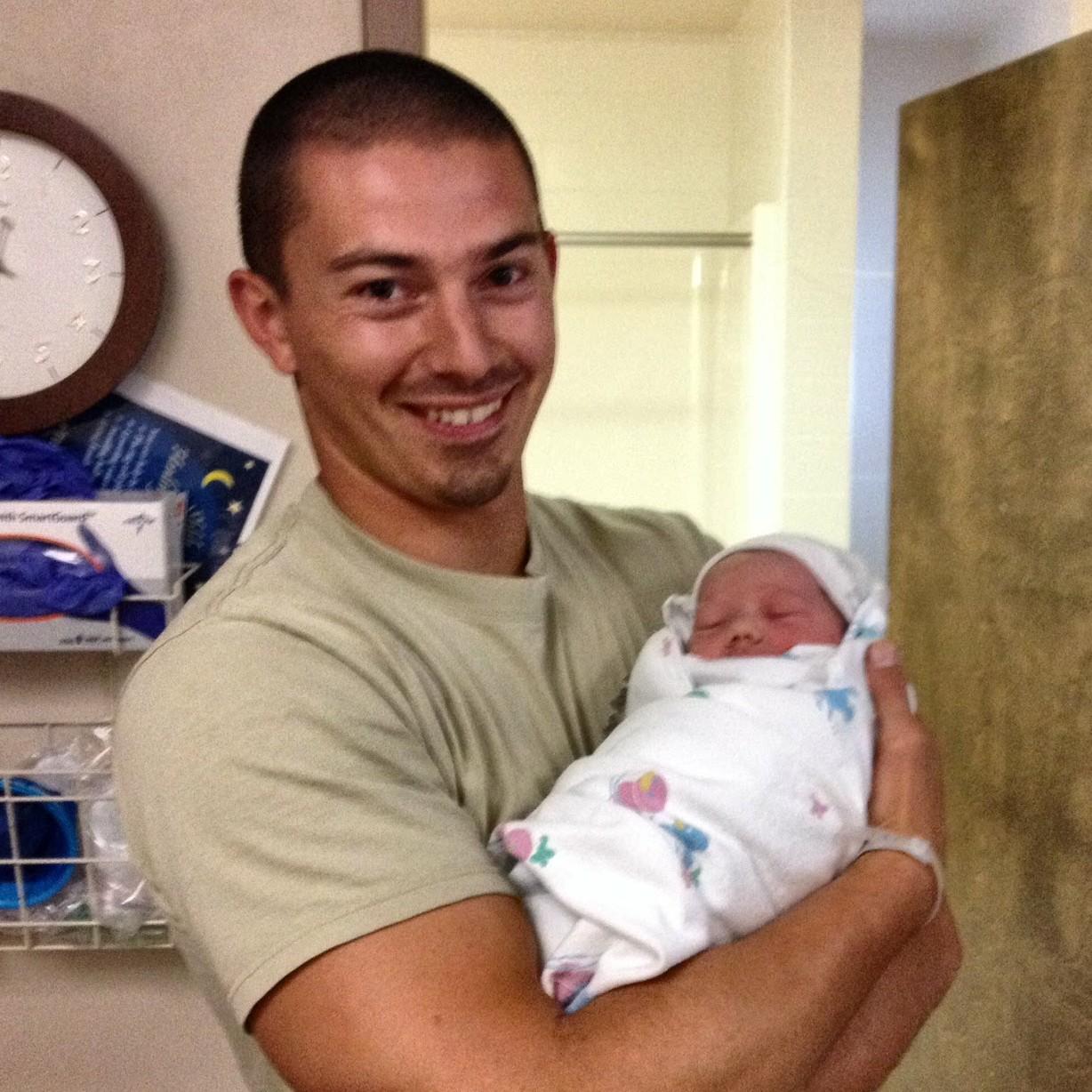 August 15th 2015 - Laramie, Wyoming - Dad Jason all smiles cuddling newborn son Jaxson