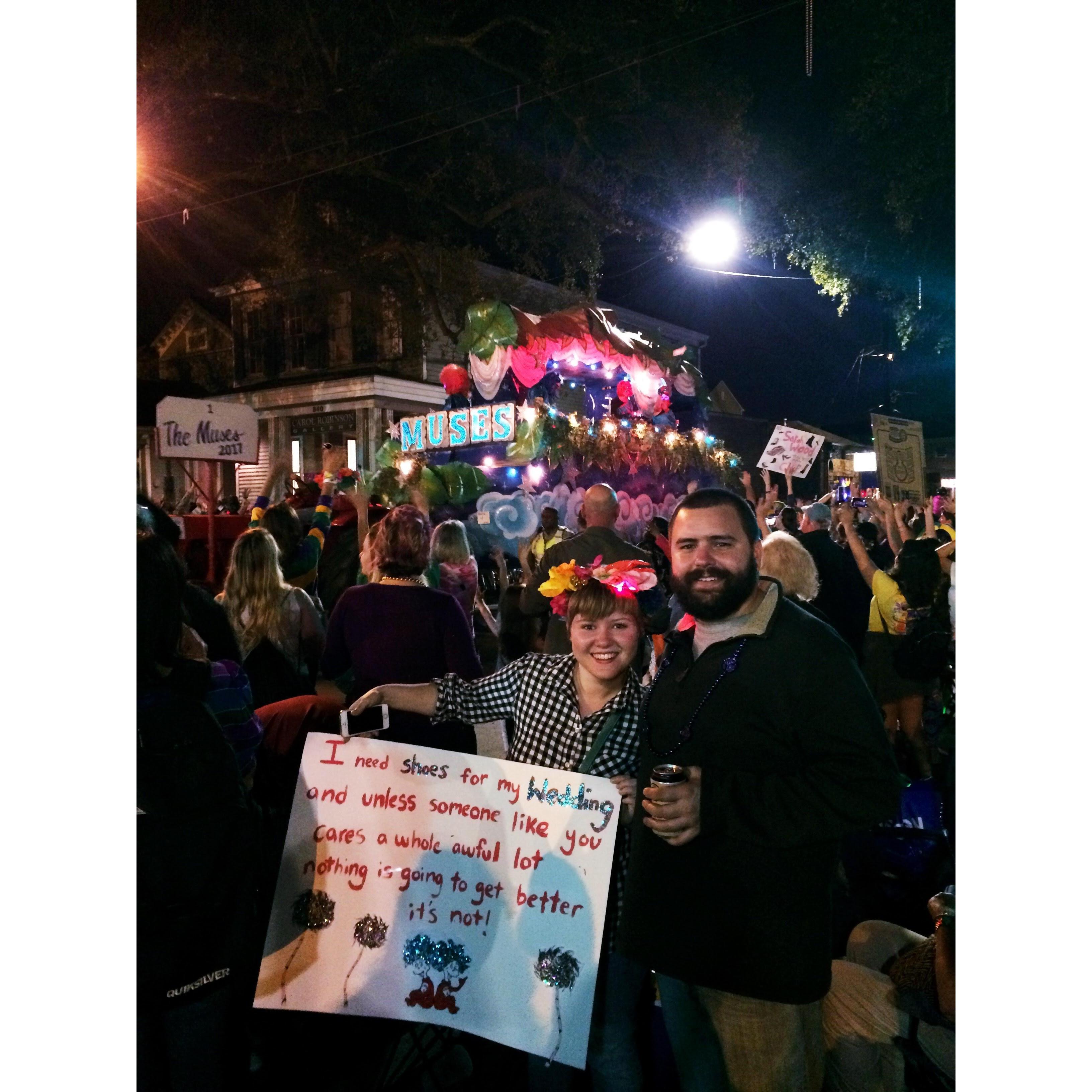 Our engagement announcement, 2017. At a Mardi Gras parade that is known for their decorated shoes they throw to the crowd.