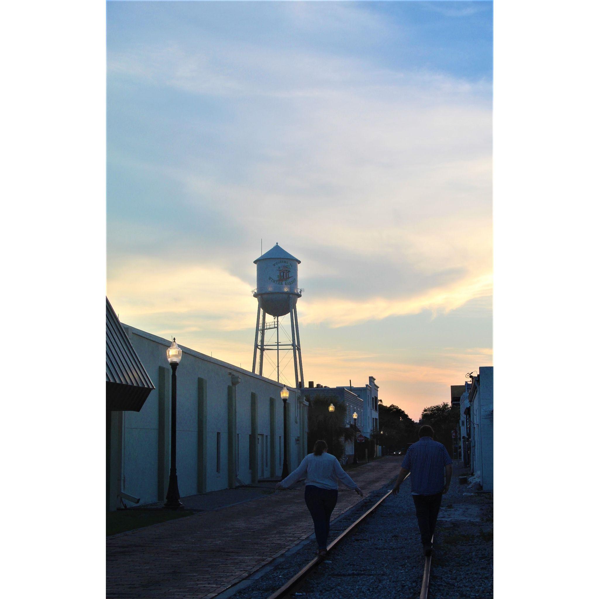 Sean and Madison walking down railroad tracks in Downtown Winter Garden