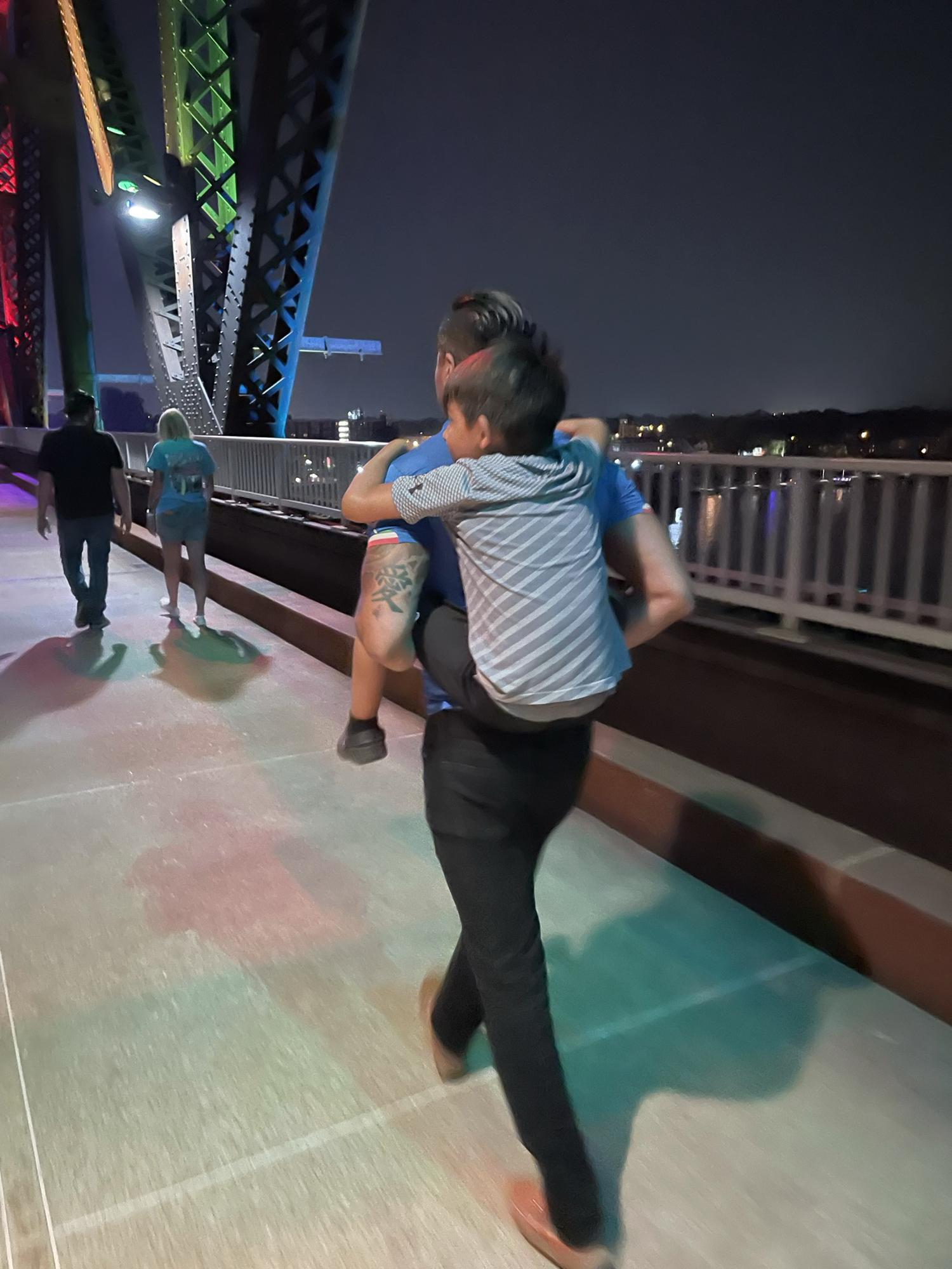 Family walks across the walking bridge - 2021